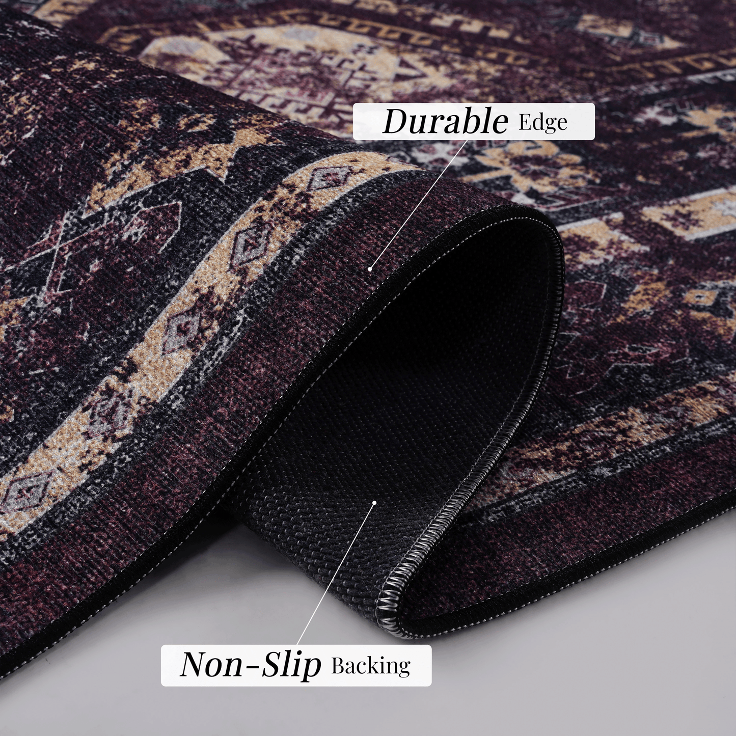 Closeup of a traditional patterned rug in burgundy and cream featuring a durable edge