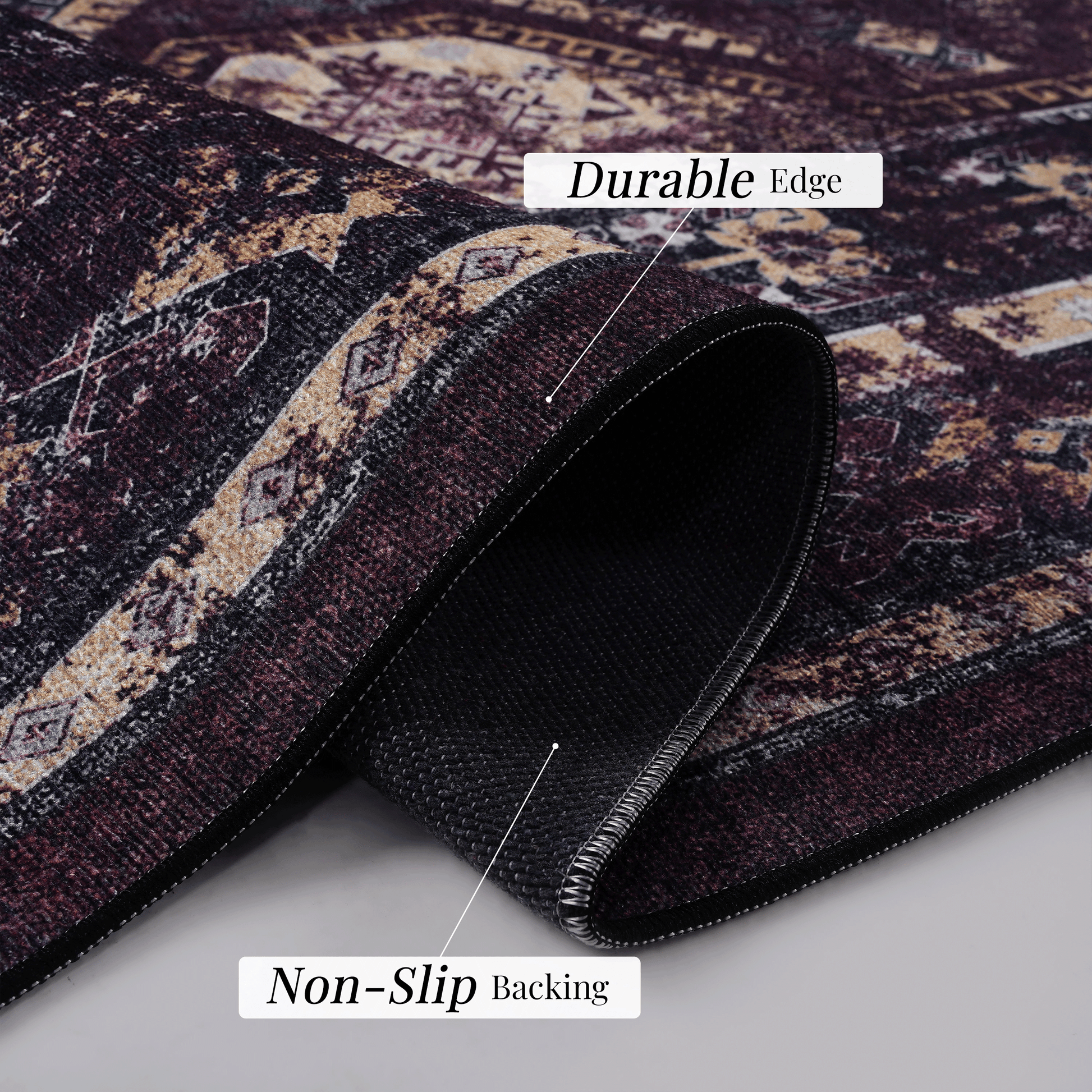 Closeup of a traditional patterned rug in burgundy and cream featuring a durable edge