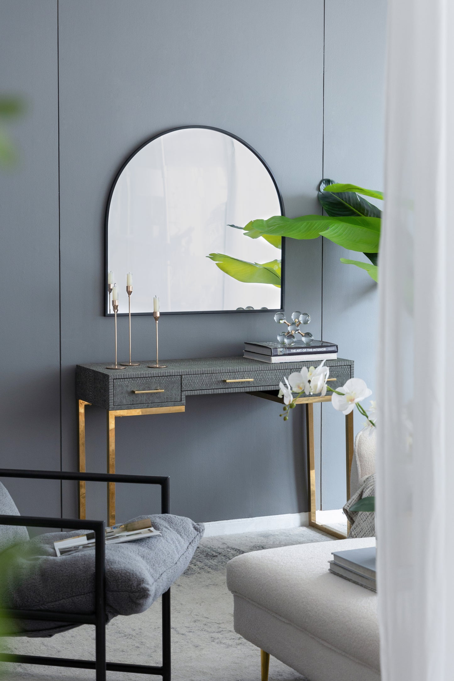 Gray textured console table with gold legs and mirror