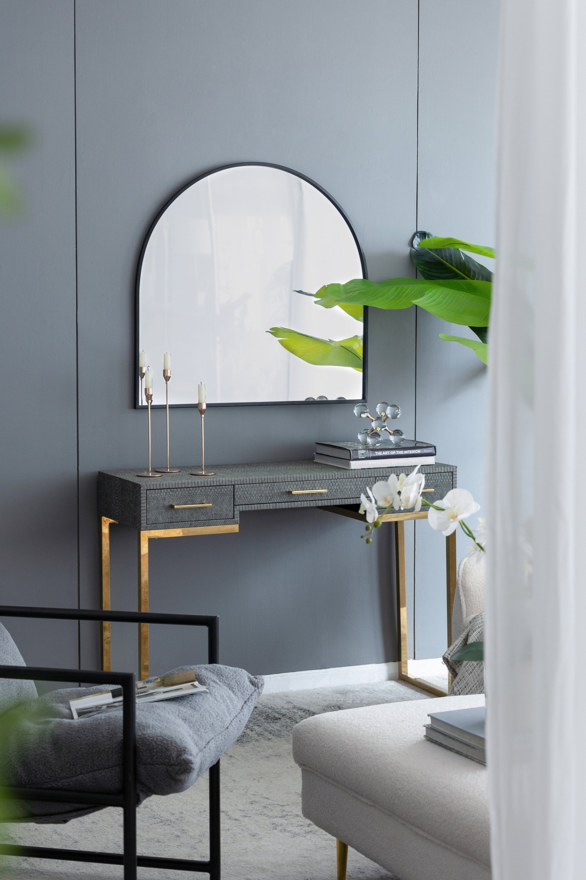 Gray textured console table with gold legs and mirror