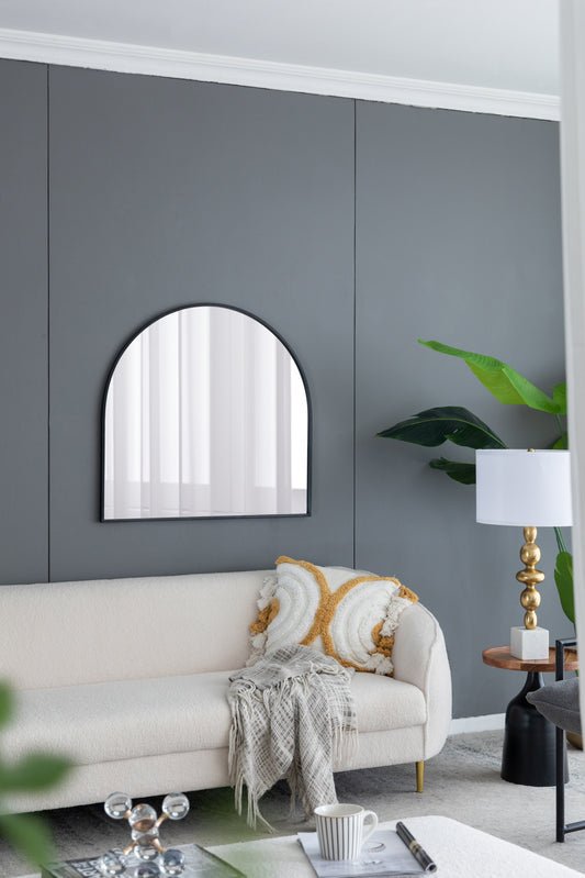 Black metal arched mirror with a rounded top perfect for a contemporary entryway or living room