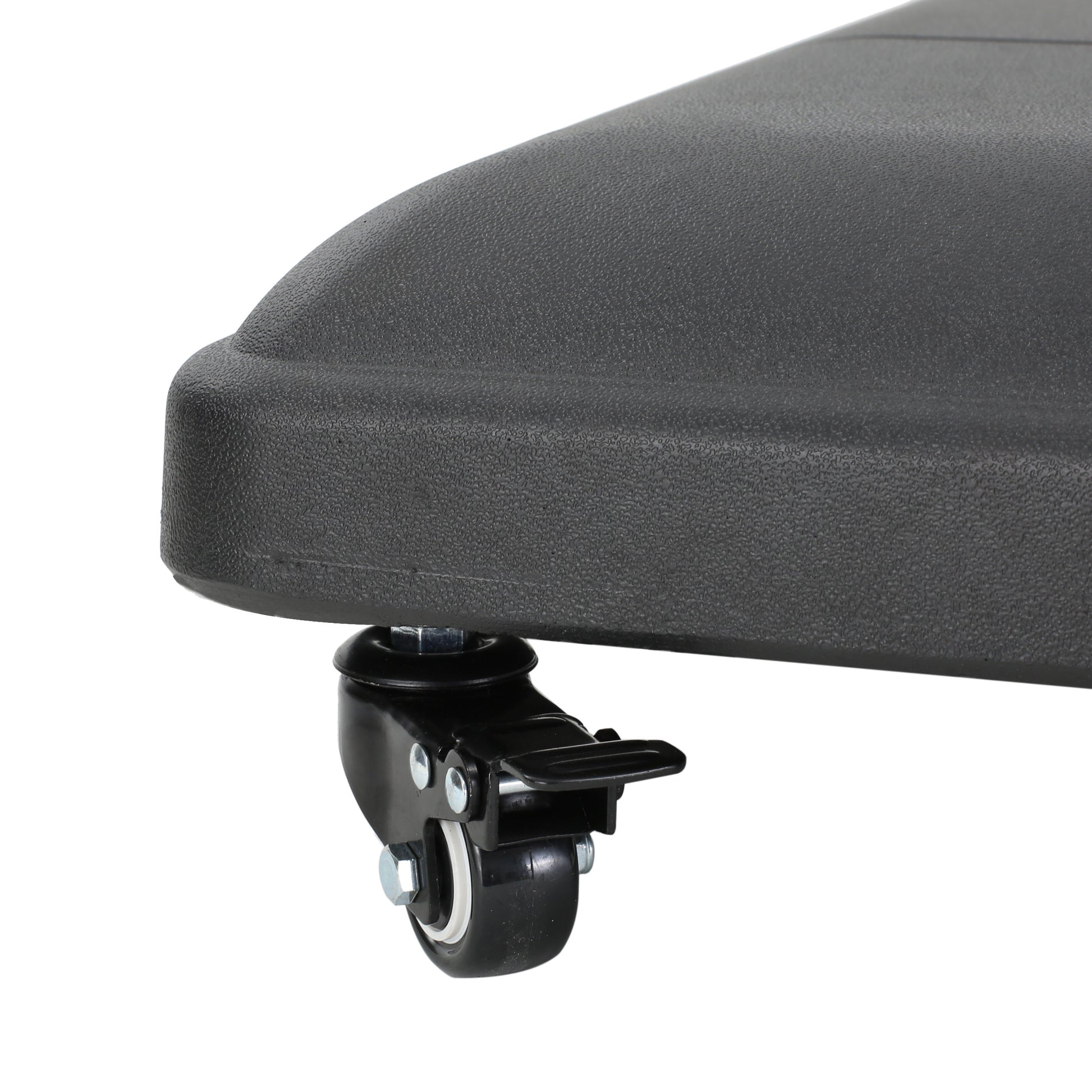 Closeup of a black textured rolling wheel with a lock on an outdoor furniture base