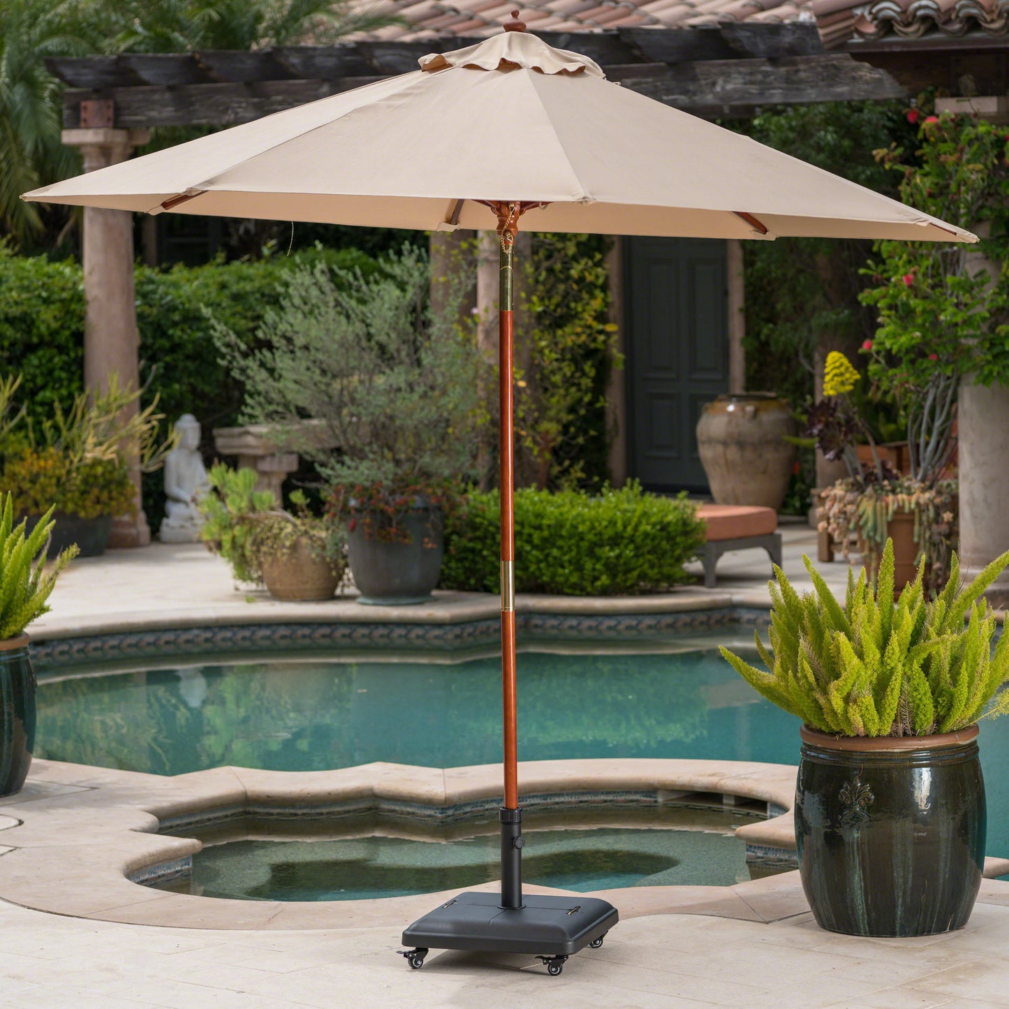 Square patio umbrella with beige canopy and wooden pole set beside a pool