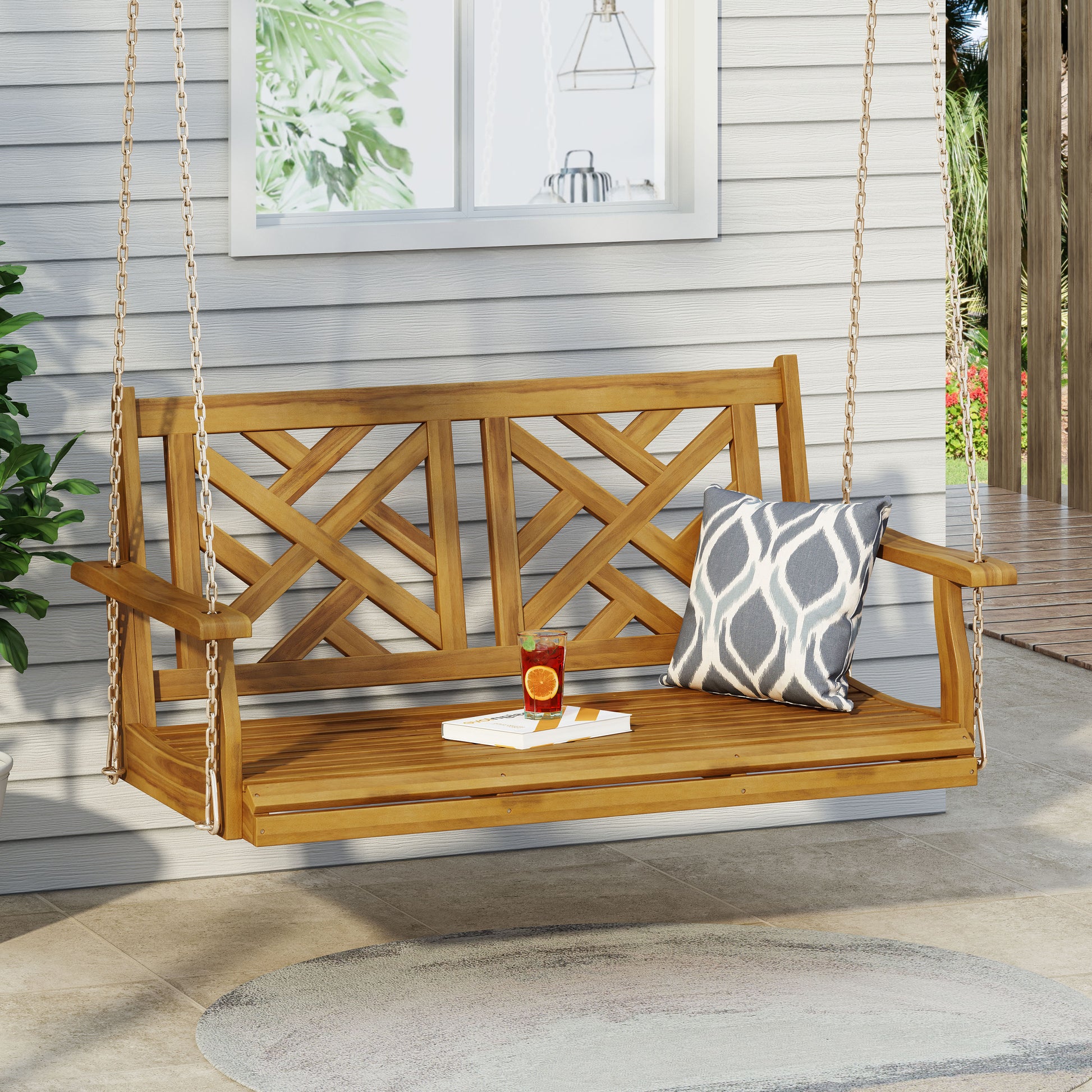 Wooden porch swing with geometric backrest and decorative pillow