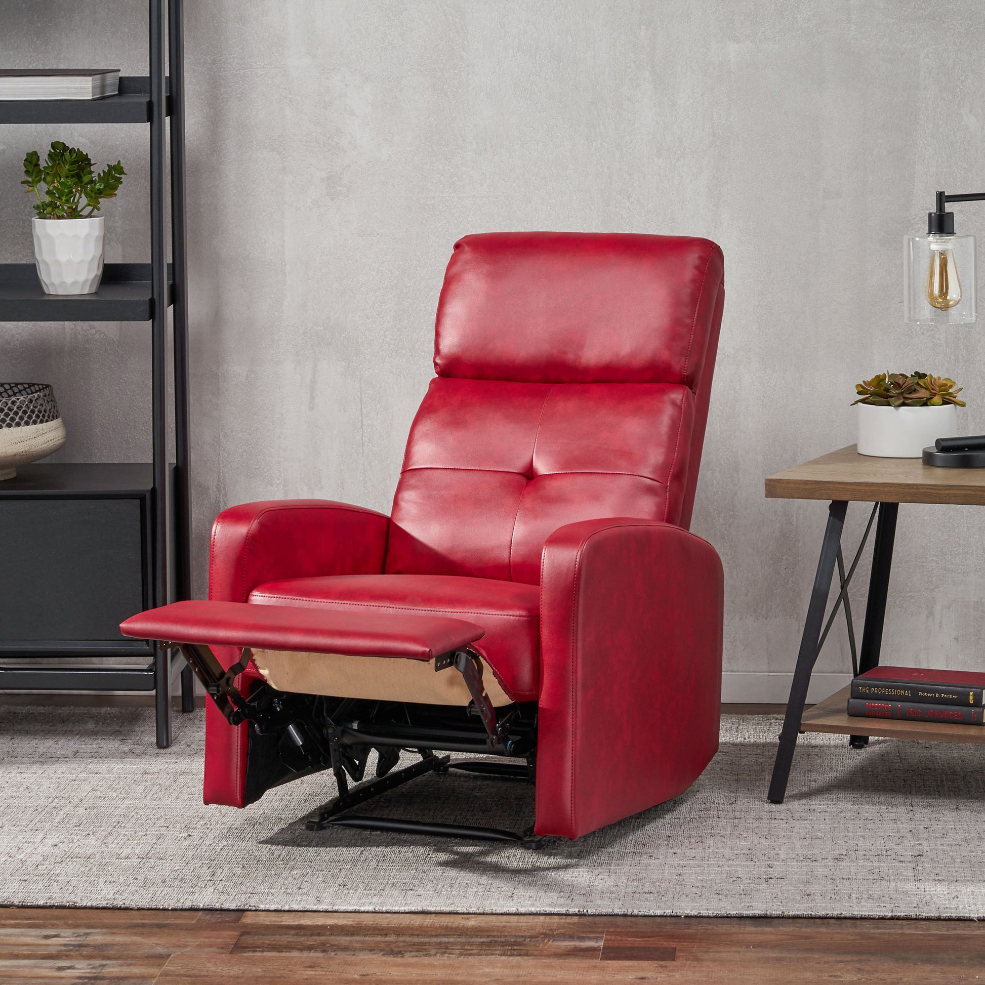 Red leather recliner chair with extended footrest and plush cushioning for comfortable seating