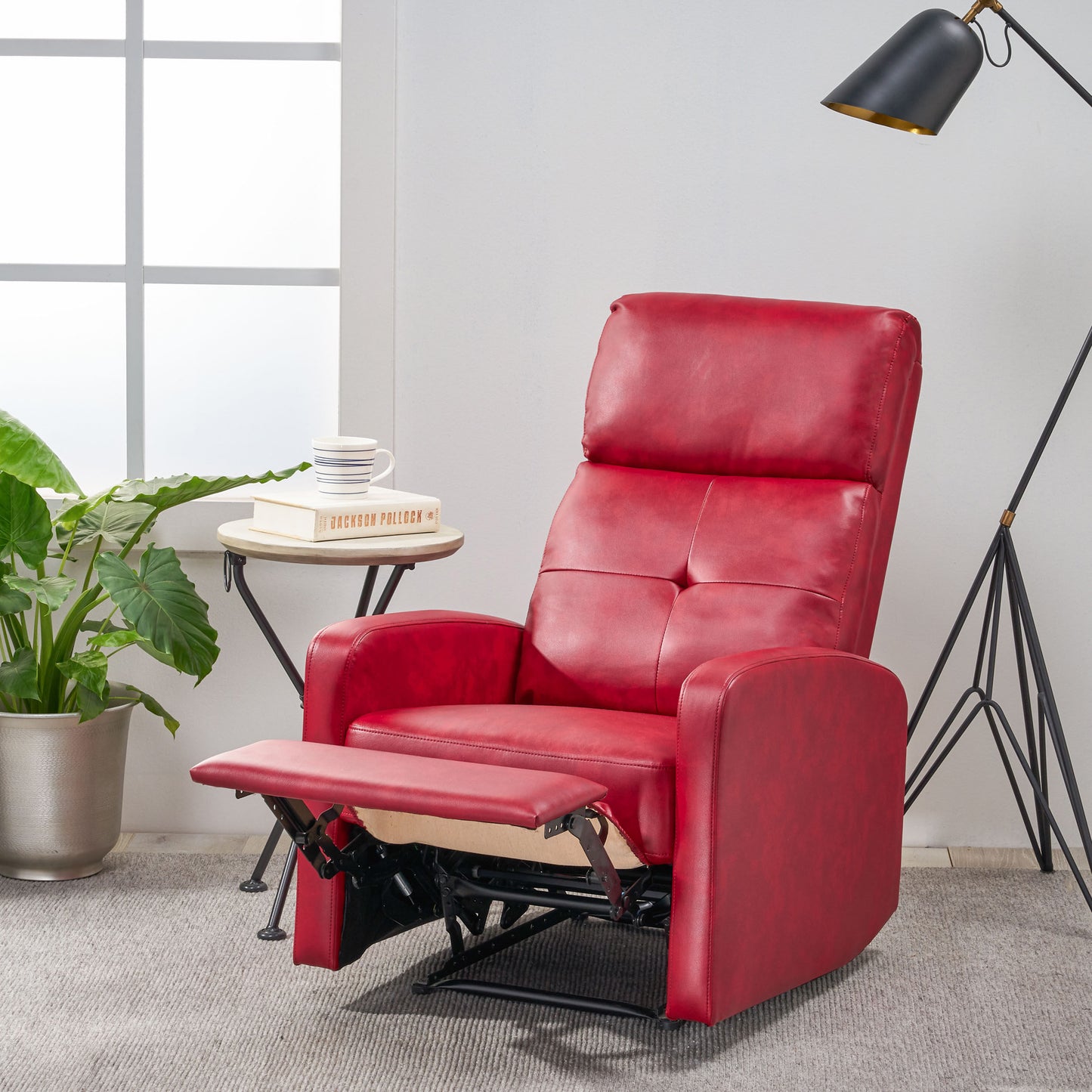 Comfortable red leather recliner with footrest extended for relaxation