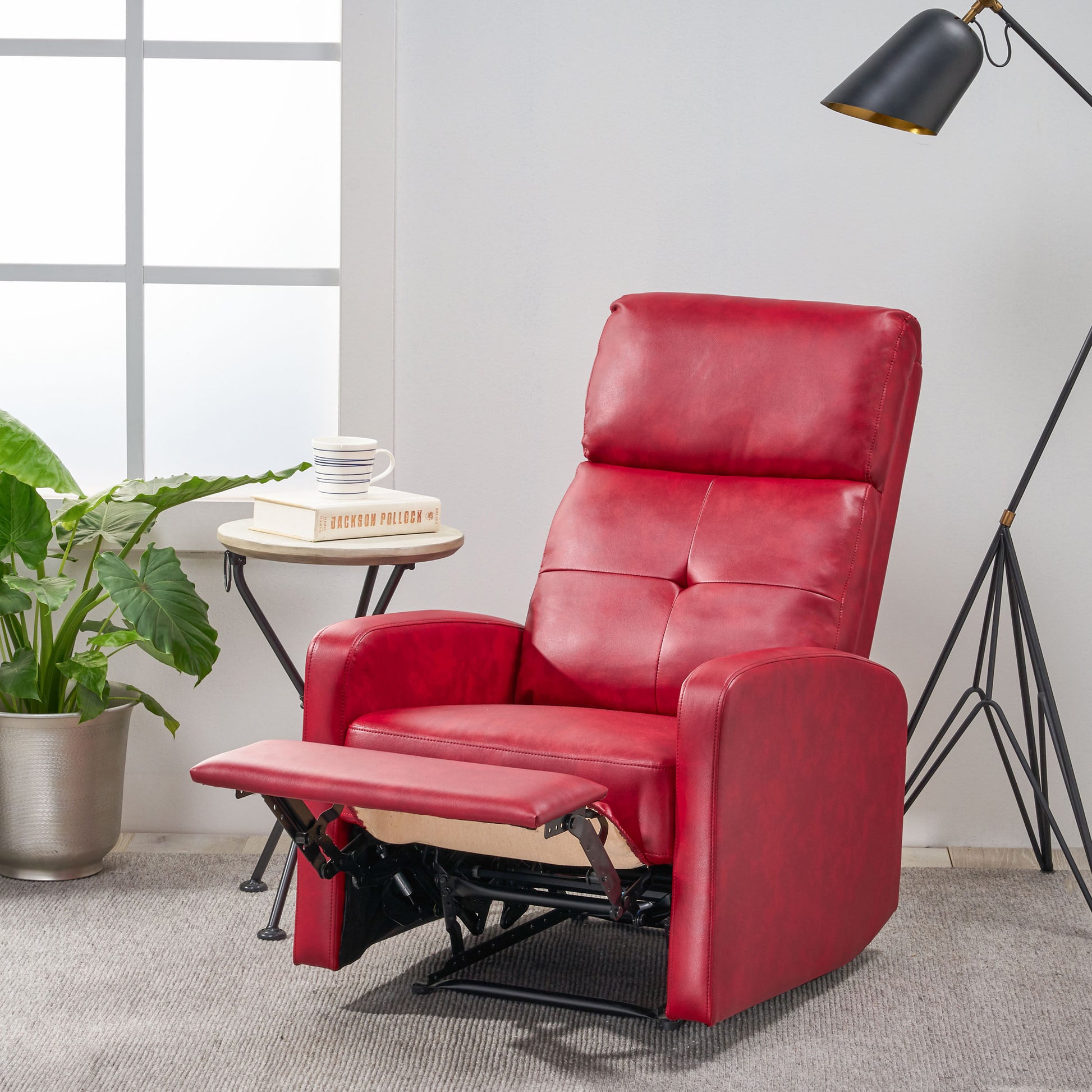 Comfortable red leather recliner with footrest extended for relaxation