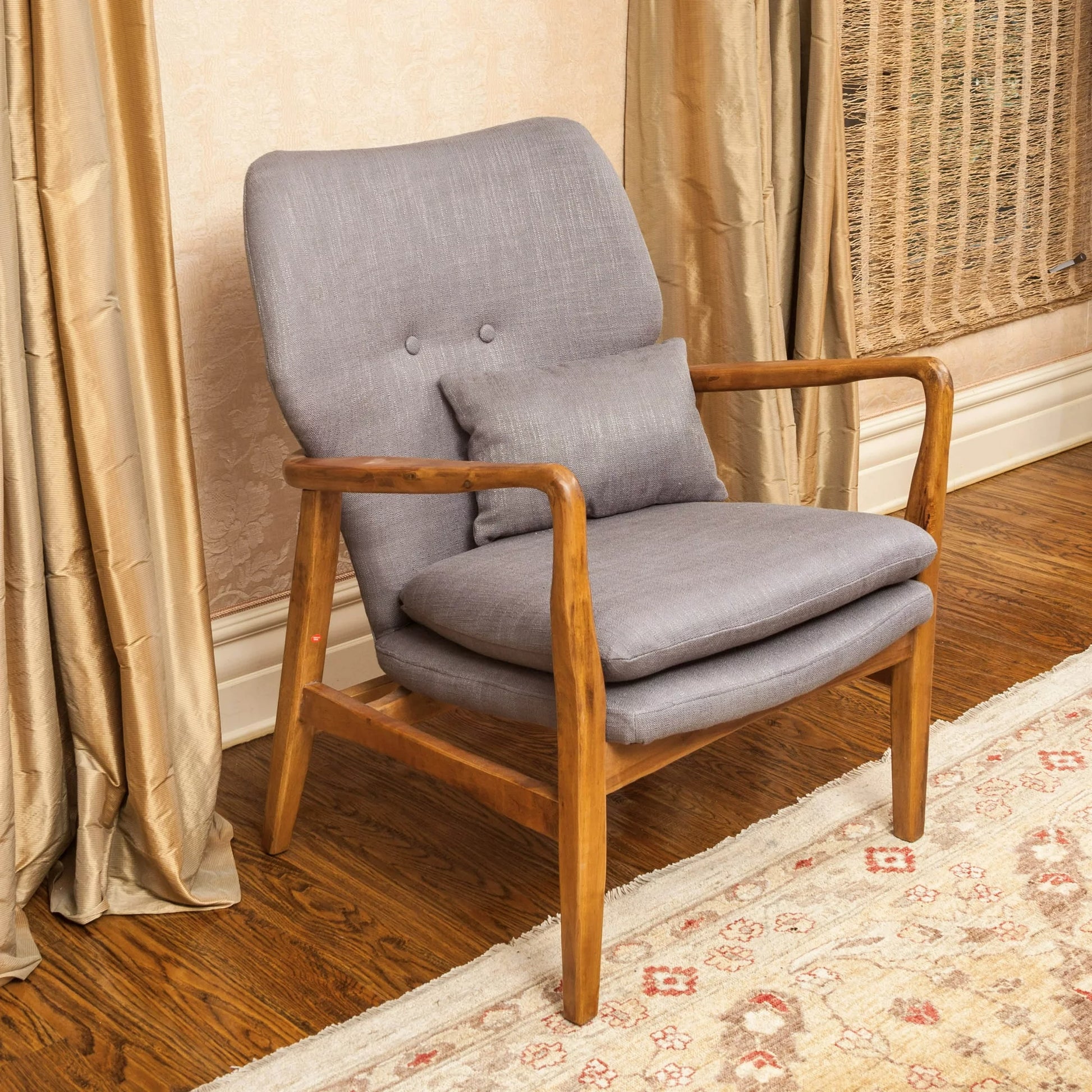 Midcentury modern armchair with grey fabric upholstery and natural wood frame featuring a low profile and comfortable seat