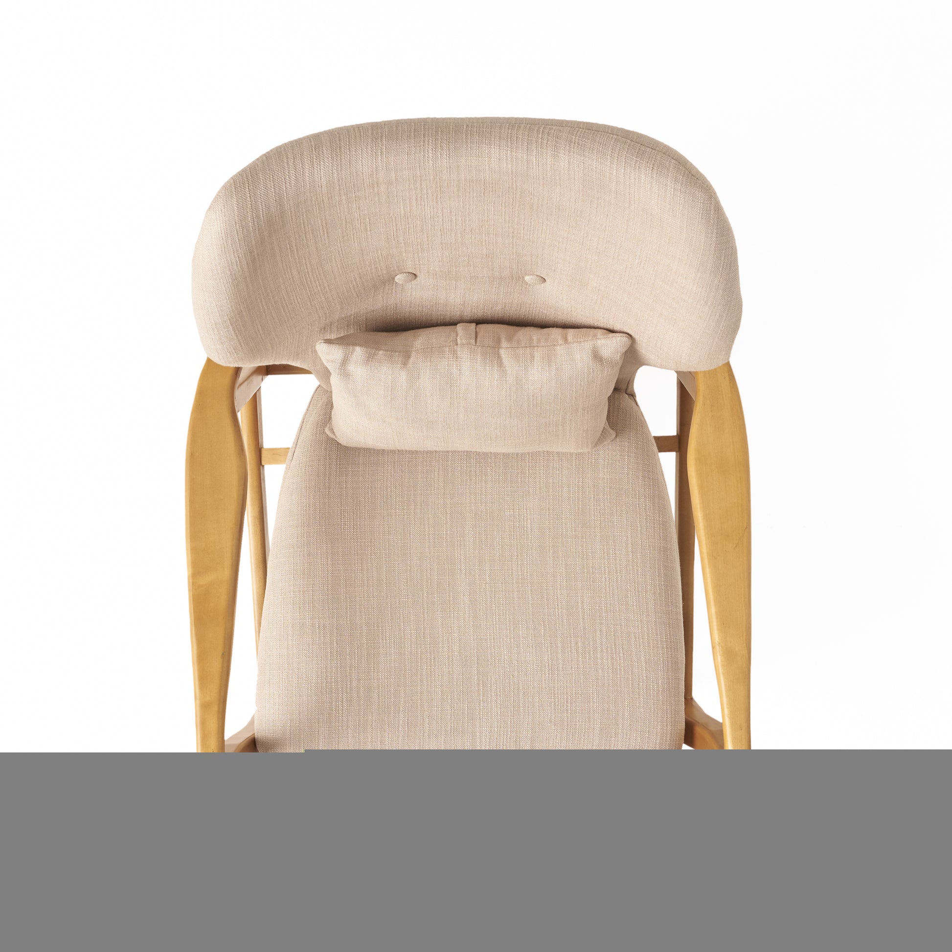 Textured beige upholstered accent chair with a lumbar pillow