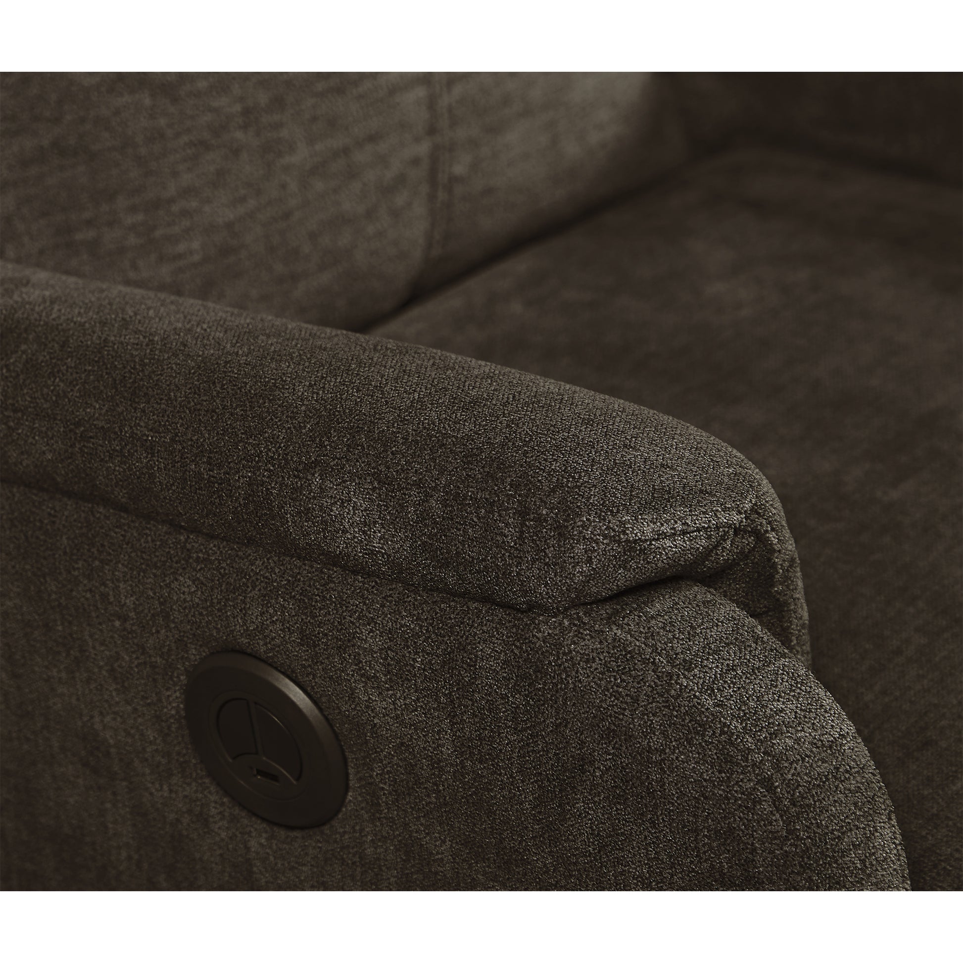 Closeup of a dark gray fabric recliner armrest with a power button detail for comfortable seating