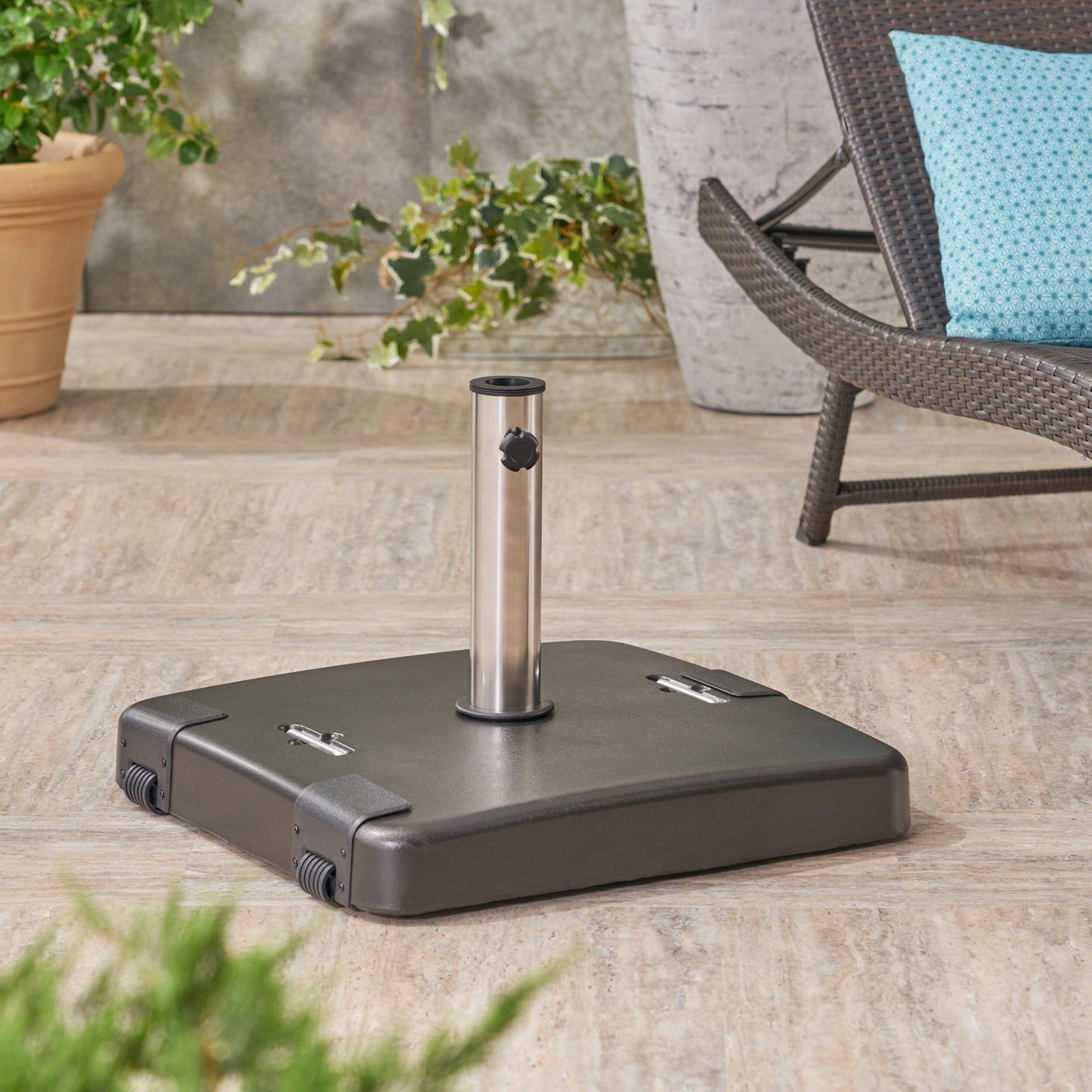 Dark gray square outdoor umbrella base with silver pole and black knob includes wheels