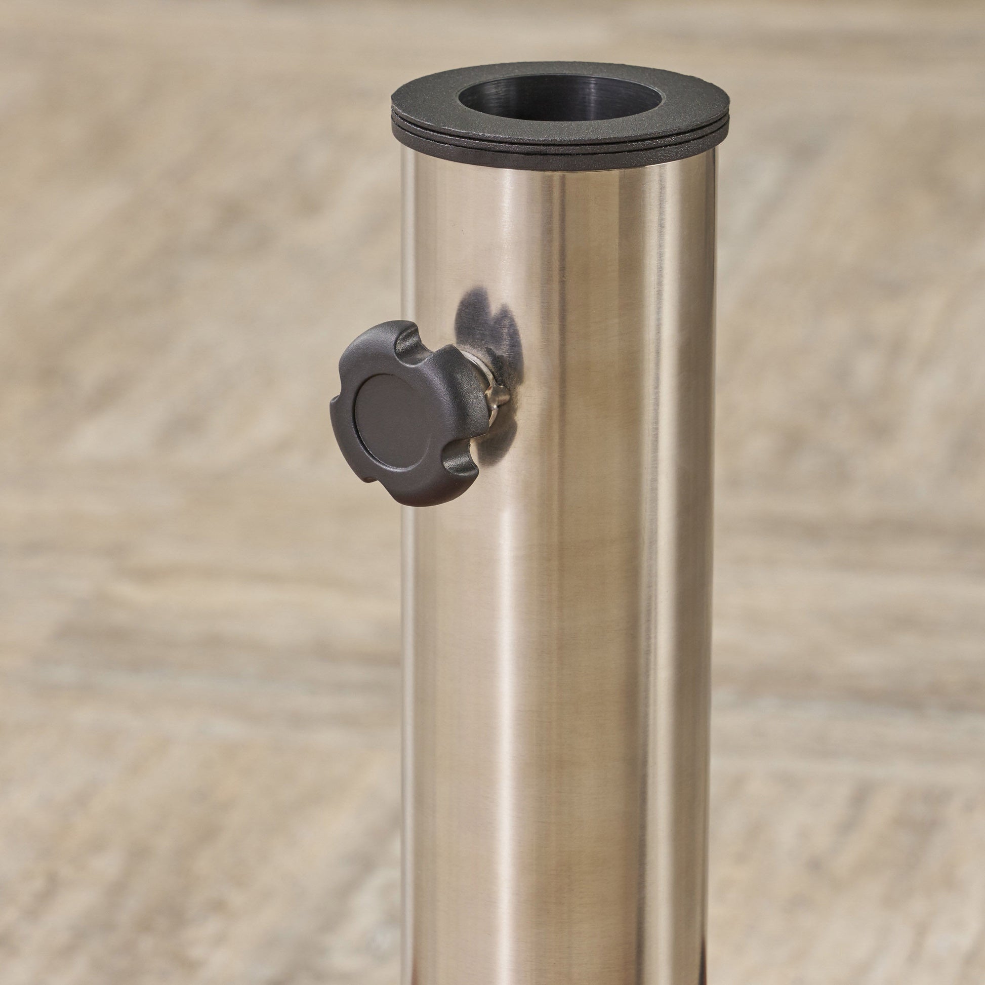 Brushed stainless steel patio umbrella stand base with black tightening knob and collar