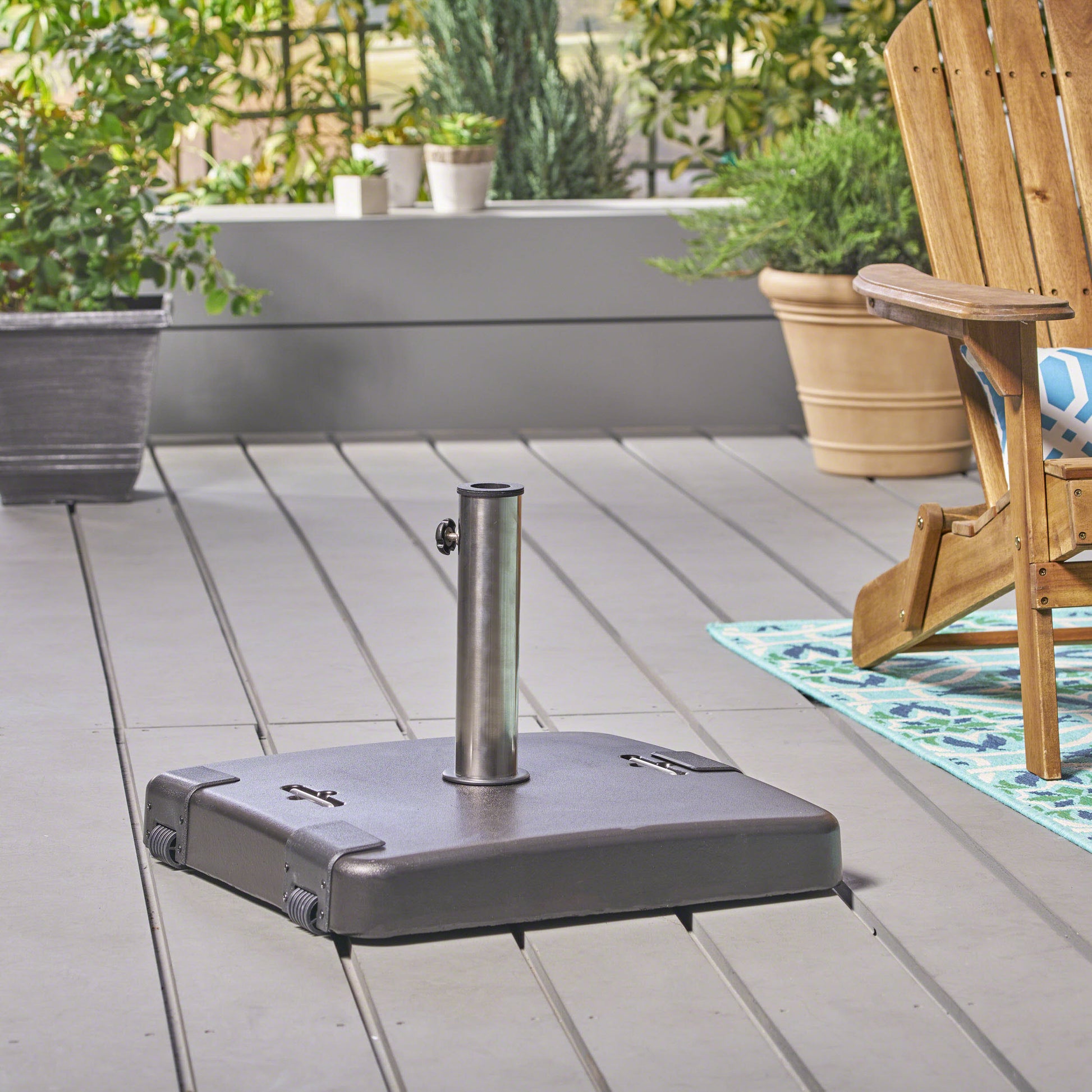 Dark gray square patio umbrella base with a silver metal pole and wheels
