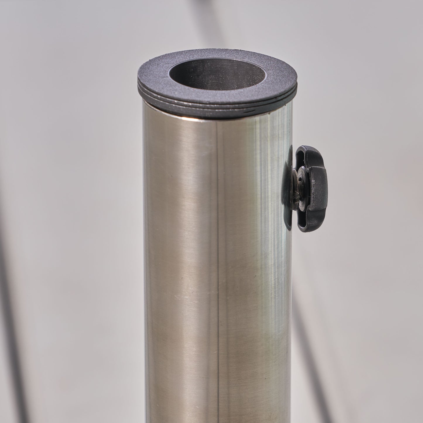 Brushed stainless steel umbrella stand with black plastic top ring and adjustable knob