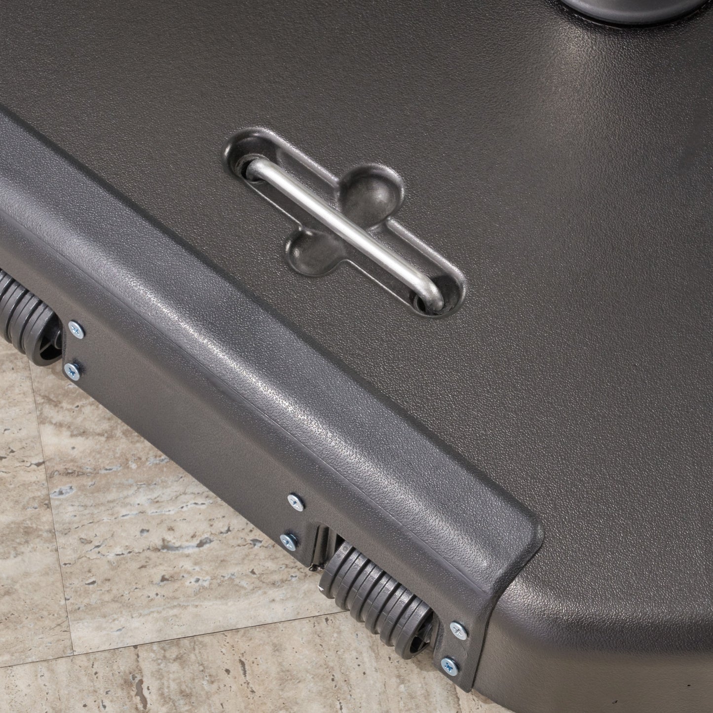 Closeup of a textured dark gray plastic base with a metal handle for this patio umbrella stand