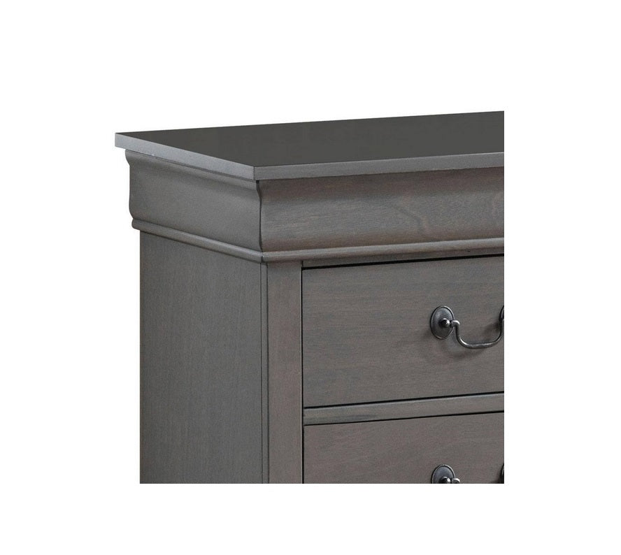 Gray wooden dresser detail with ornate drawer pulls