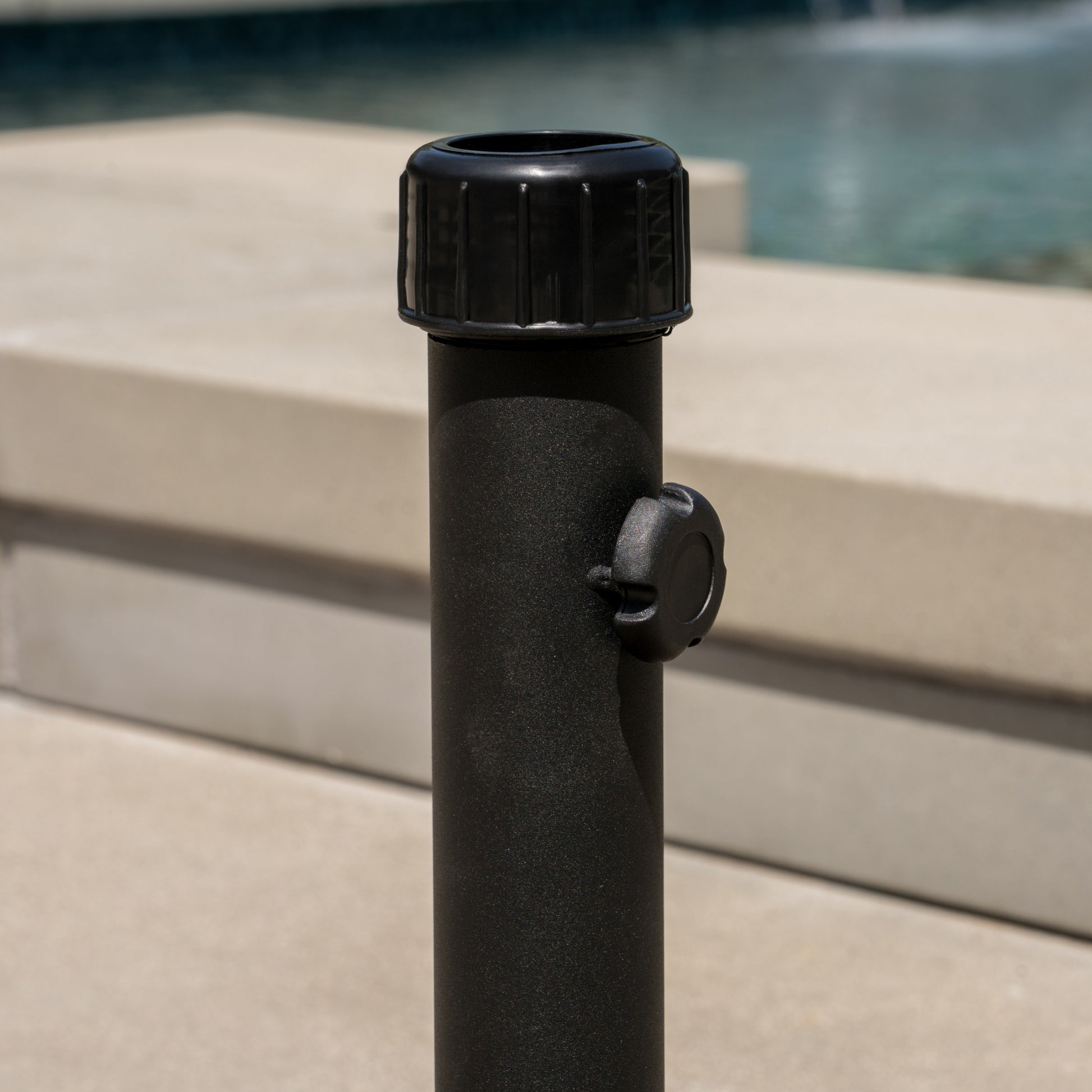 Black textured umbrella pole with adjustable knob for outdoor use