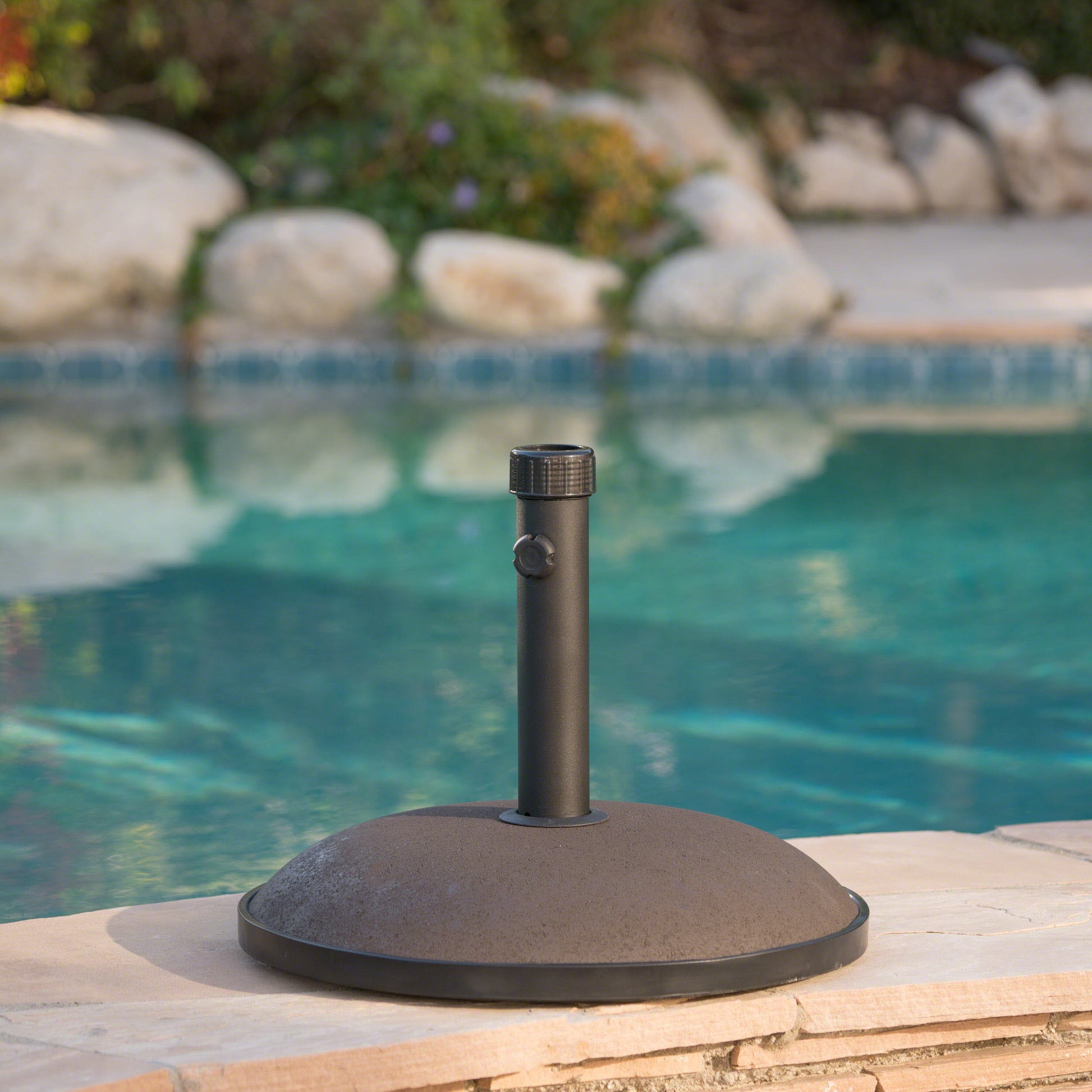 Dark gray textured umbrella base with a central pole for patio shade