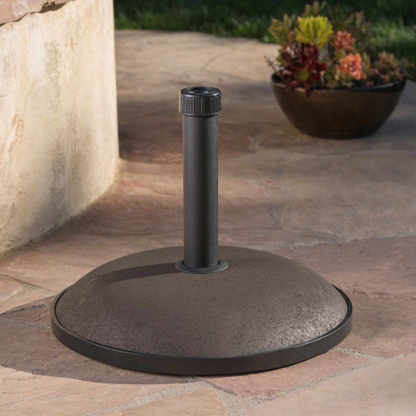 Dark gray concrete patio umbrella stand with textured finish and metal pole