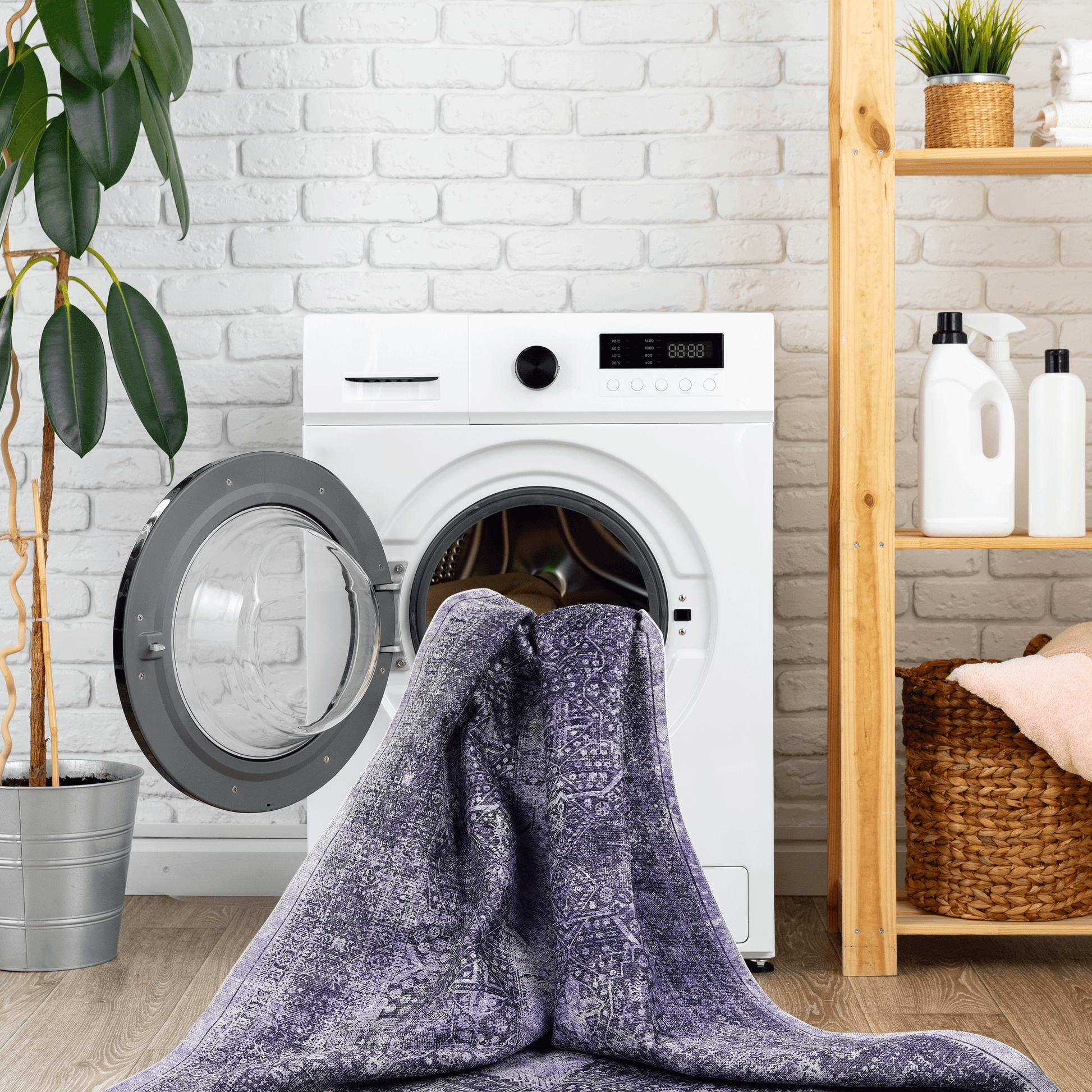Washing machine with open door holding a distressed purple oriental rug