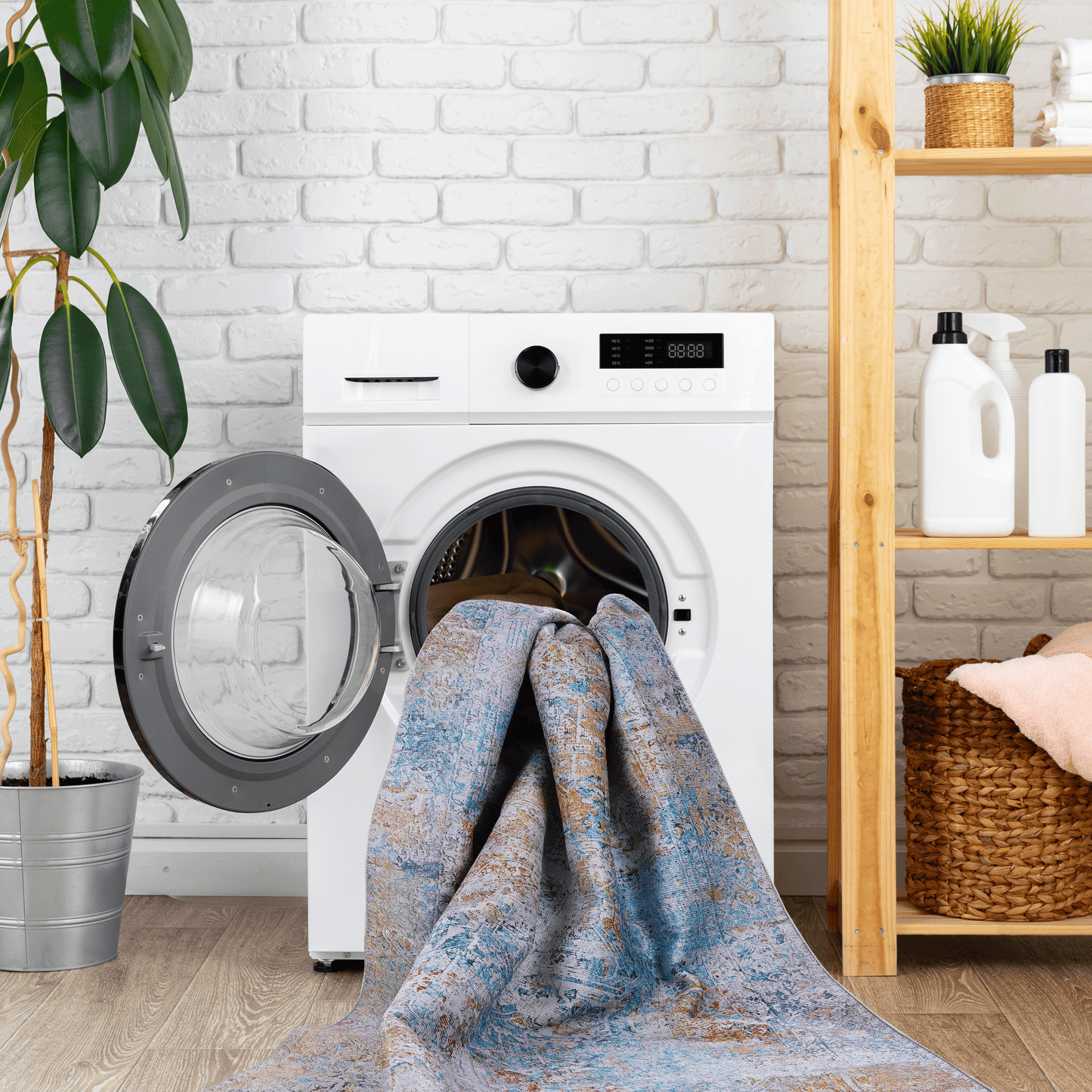 Persianstyle rug with distressed blue orange and cream patterns being loaded into a washing machine