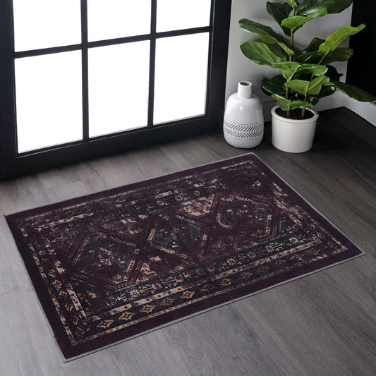 Dark red distressed Persian rug with ornate geometric patterns on a wood floor