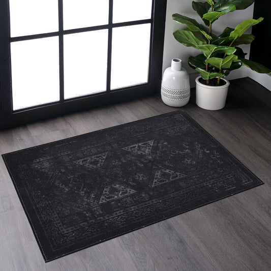 Distressed black Oriental rug with geometric pattern and faded finish for modern living rooms