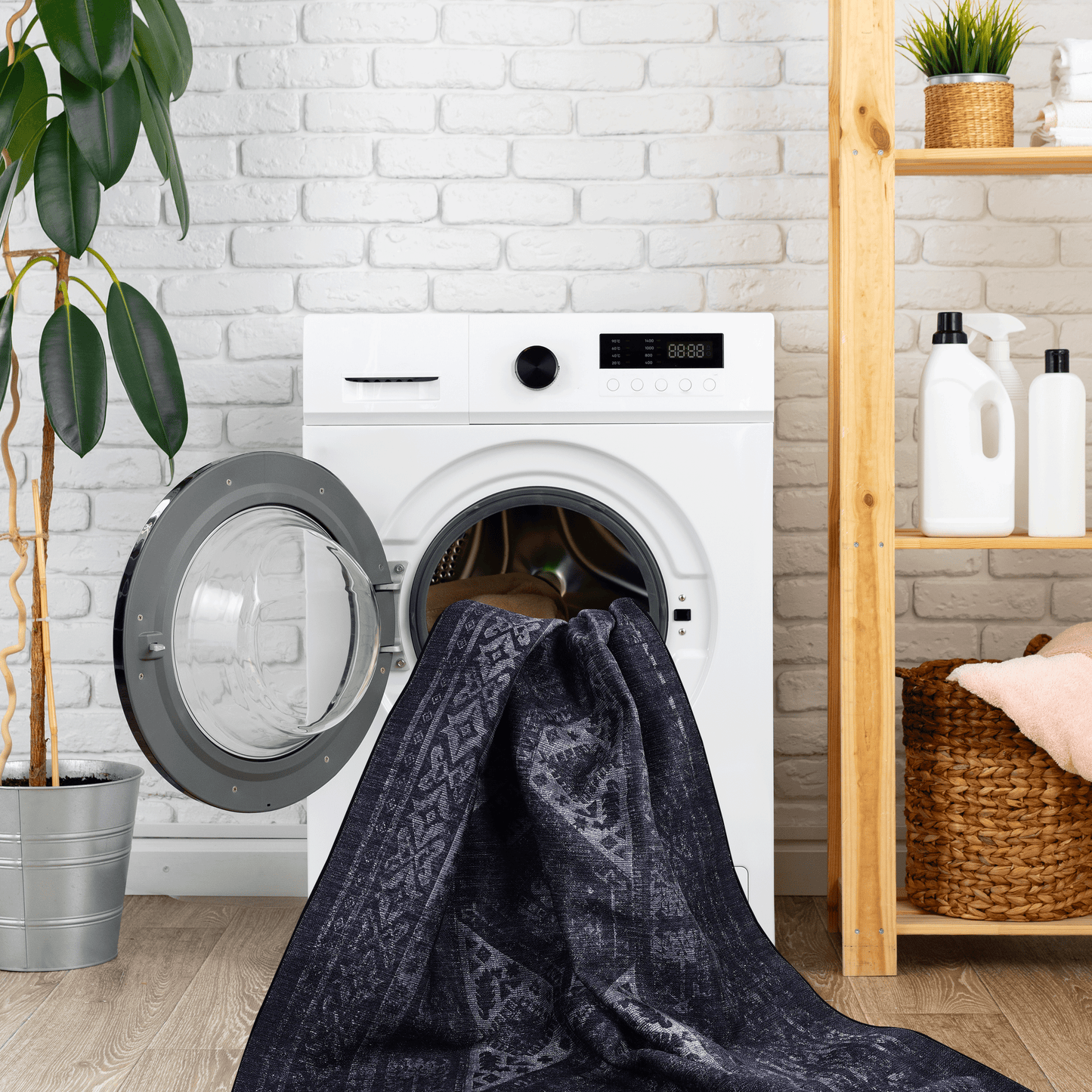 Dark blue abstract pattern area rug draped partially into a washing machine