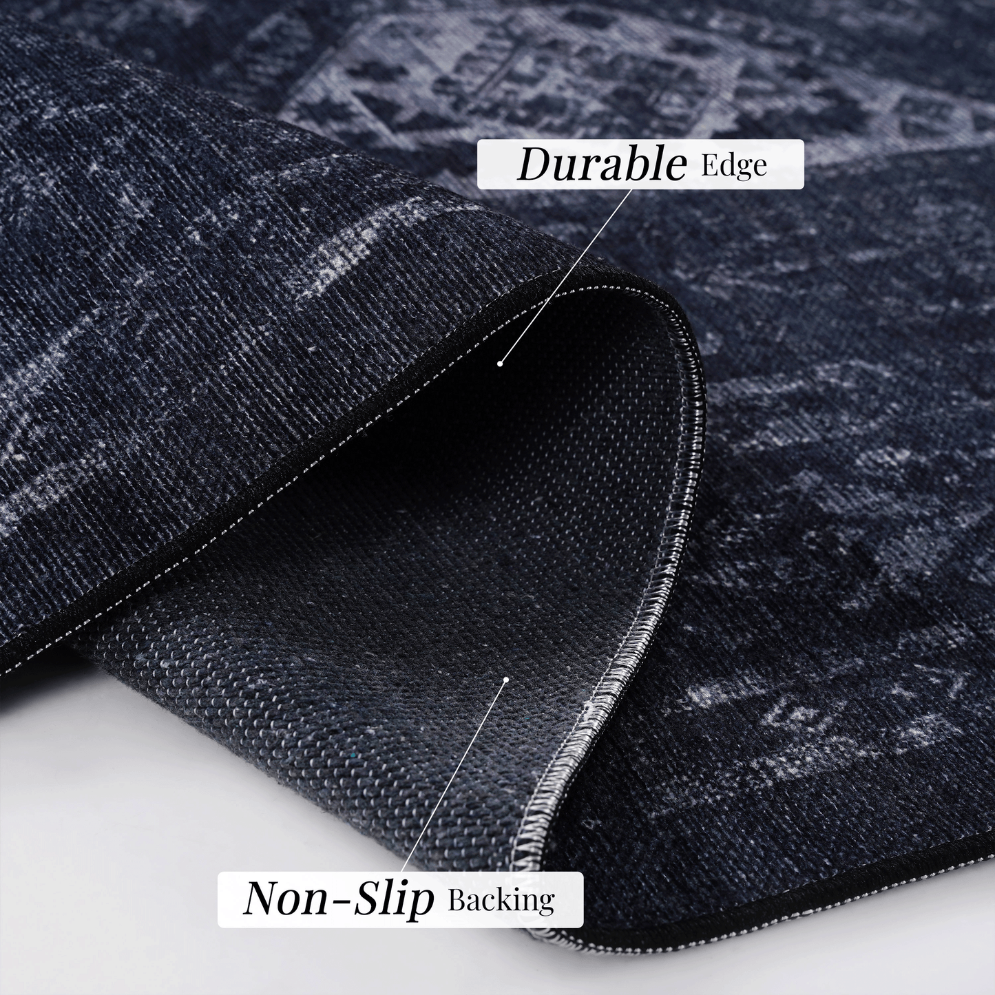 Dark navy distressed rug with a durable edge and visible stitching for a classic look