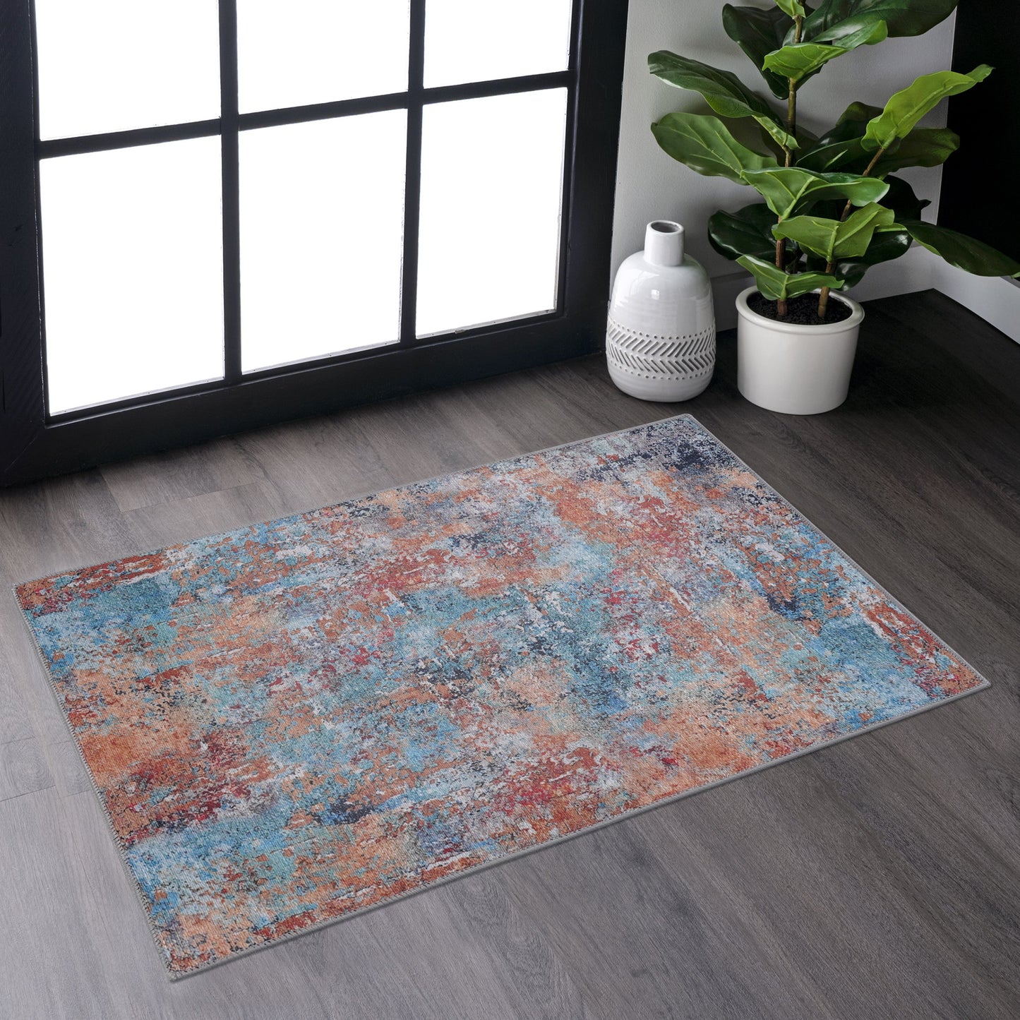 Distressed abstract area rug with blue orange and gray tones