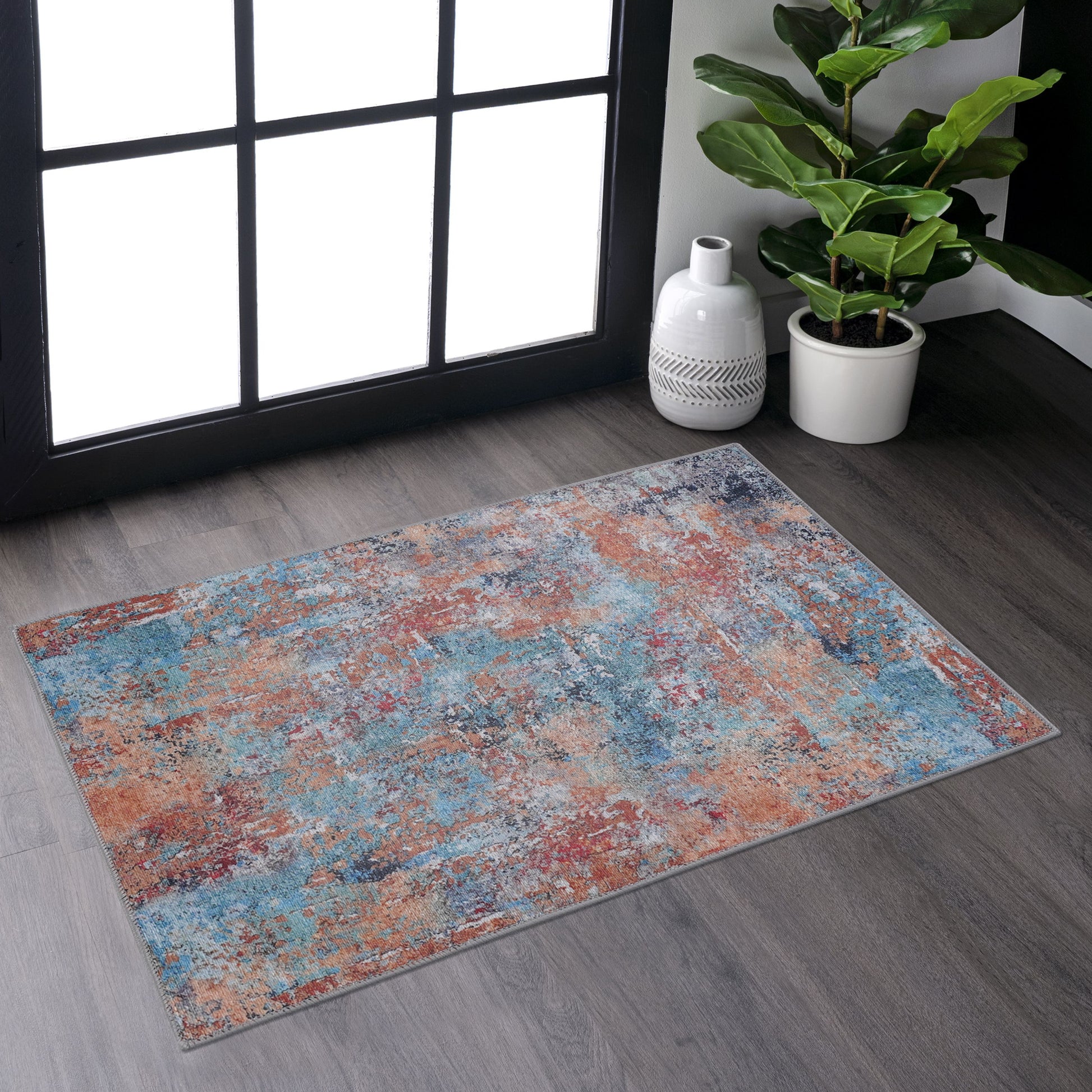 Distressed abstract area rug with blue orange and gray tones