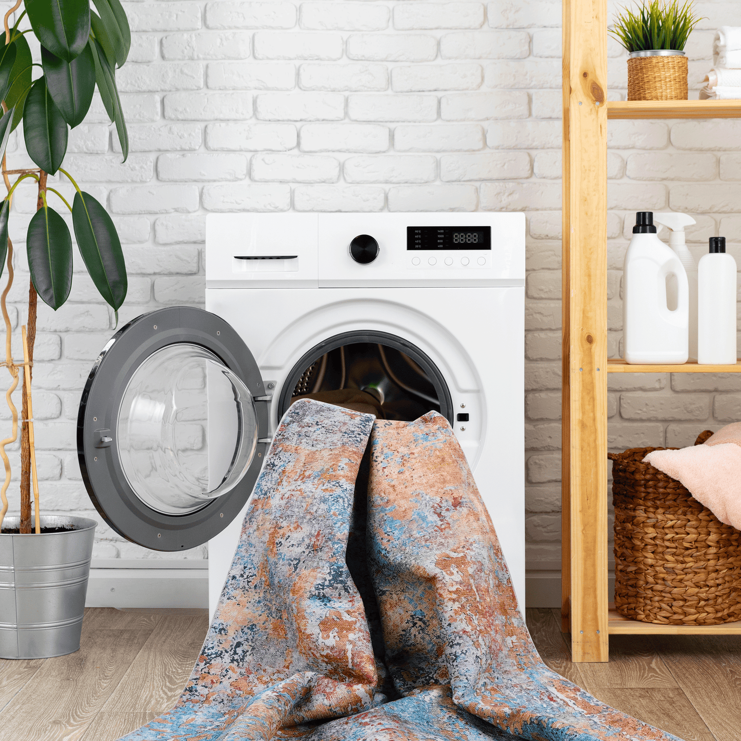 Abstract design rug with blue orange and grey tones being loaded into washing machine