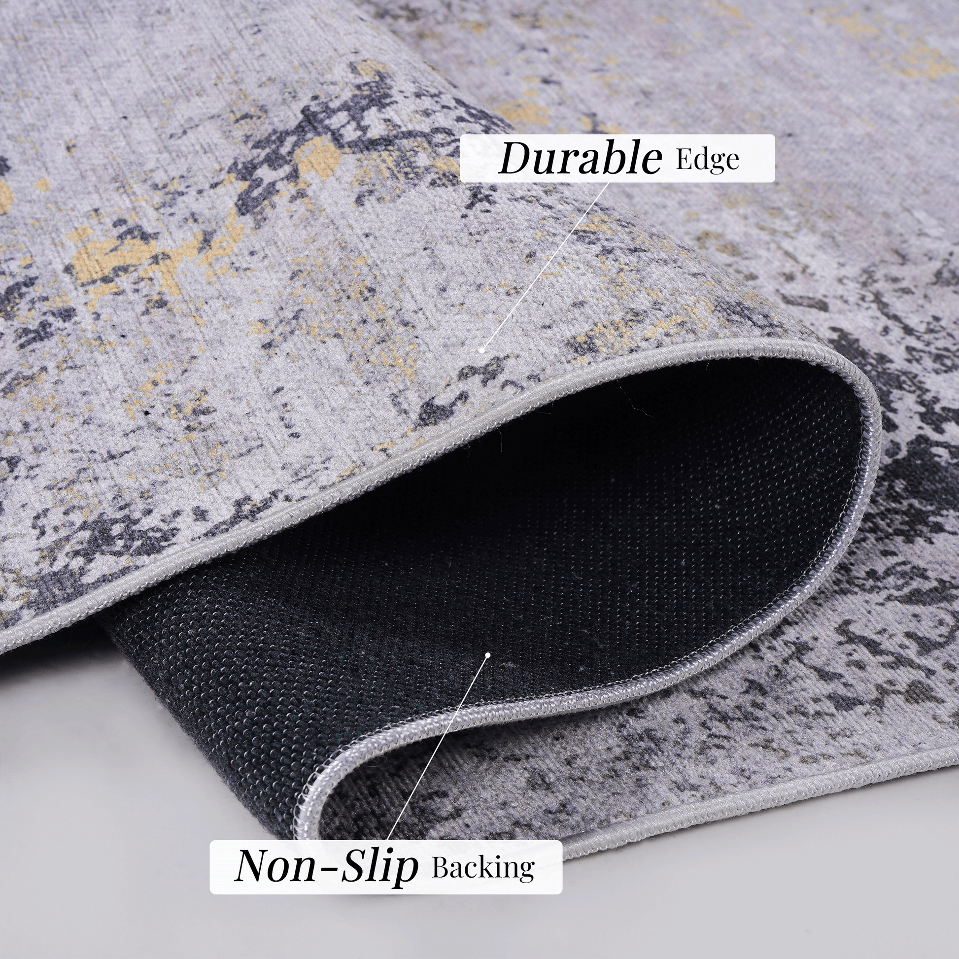 Closeup of a grey and gold abstract pattern modern rug with a nonslip backing and durable edge
