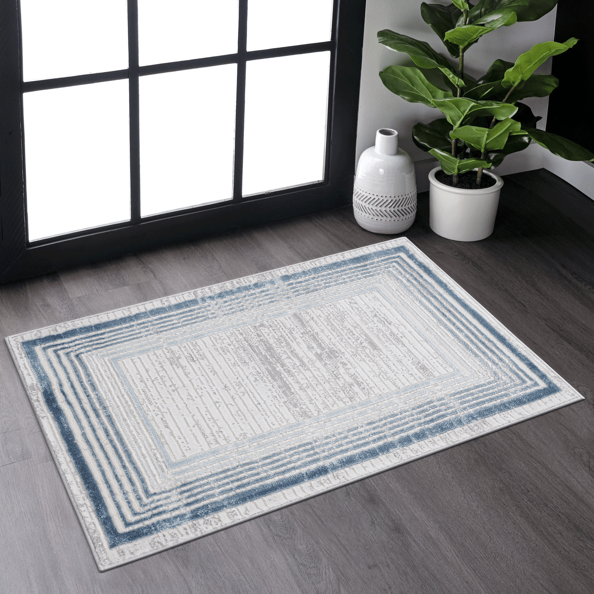 Rectangular area rug with a distressed blue and beige geometric pattern perfect for living rooms
