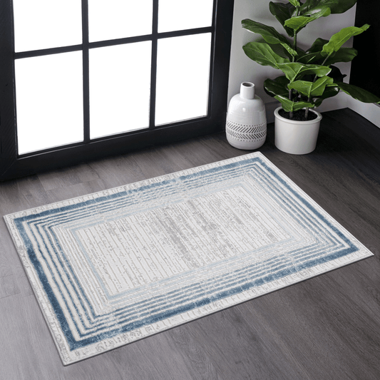 Rectangular area rug with a distressed blue and beige geometric pattern perfect for living rooms