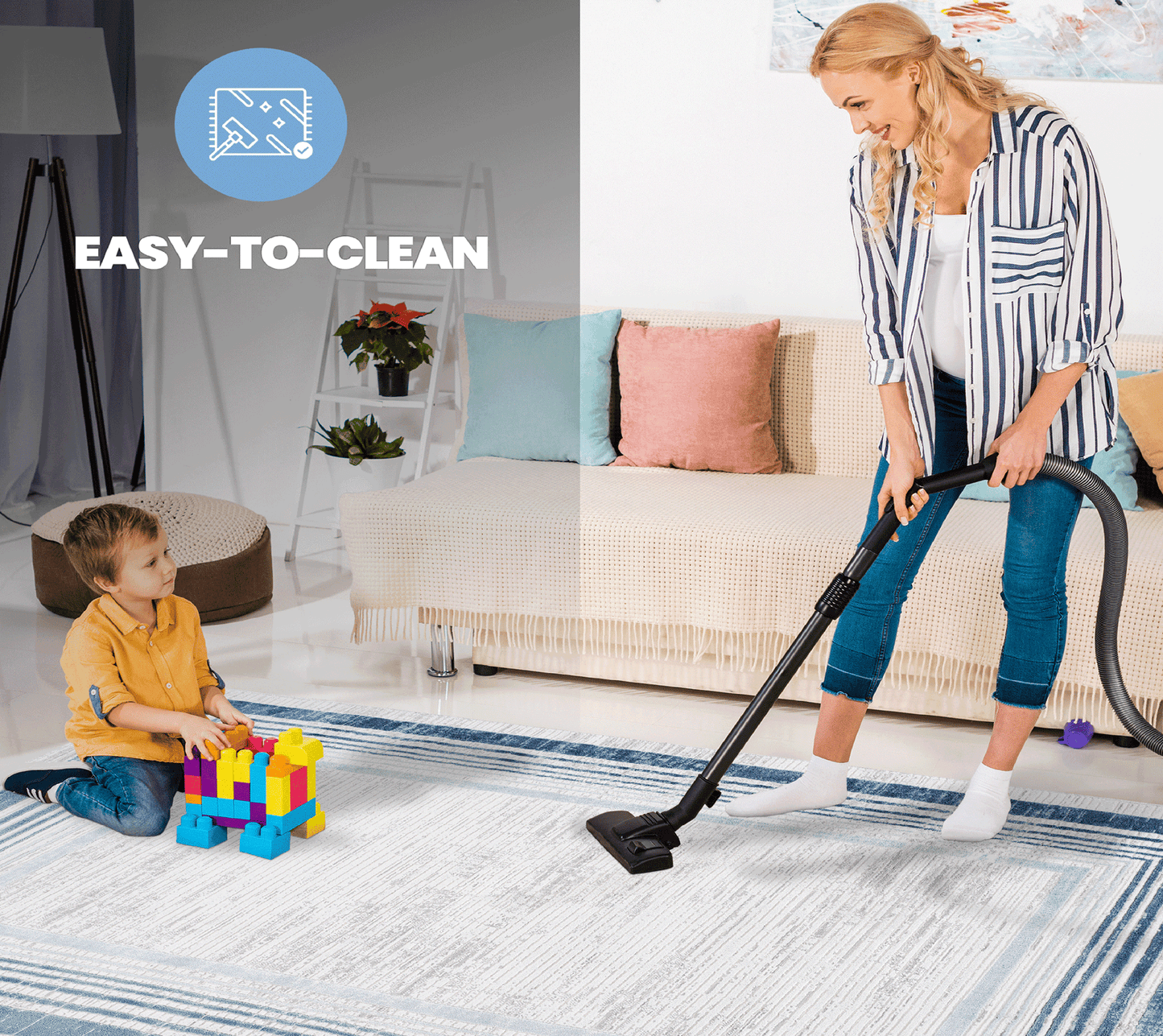 White and blue striped area rug with child playing and woman vacuuming