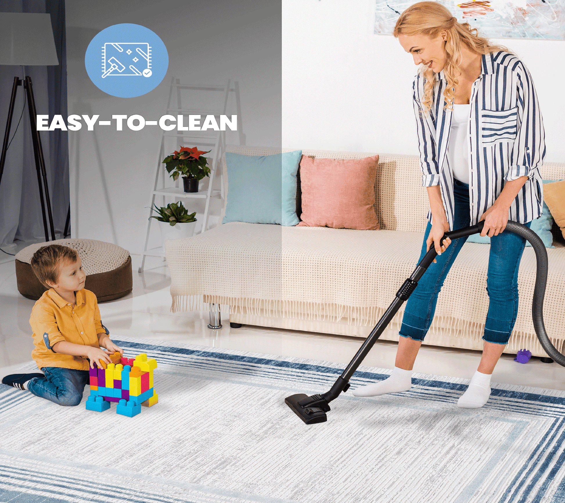 White and blue striped area rug with child playing and woman vacuuming
