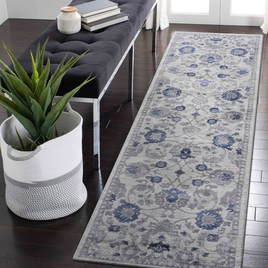 Light grey and blue floral runner rug on dark wood floor