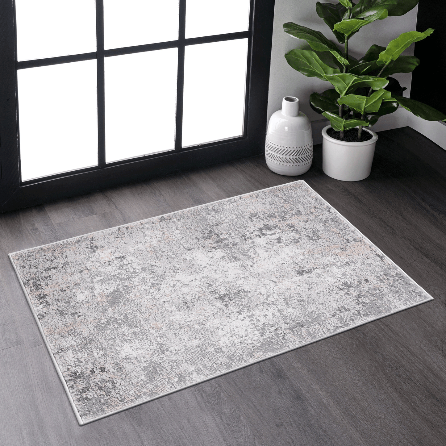 Abstract grey and cream area rug with distressed pattern and soft texture