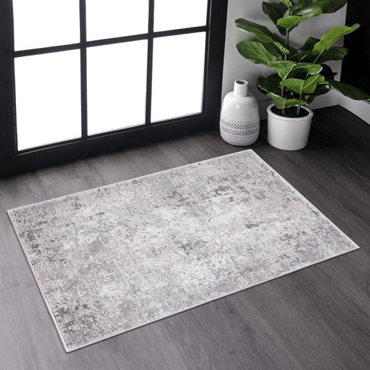 Abstract grey and cream area rug with distressed pattern and soft texture