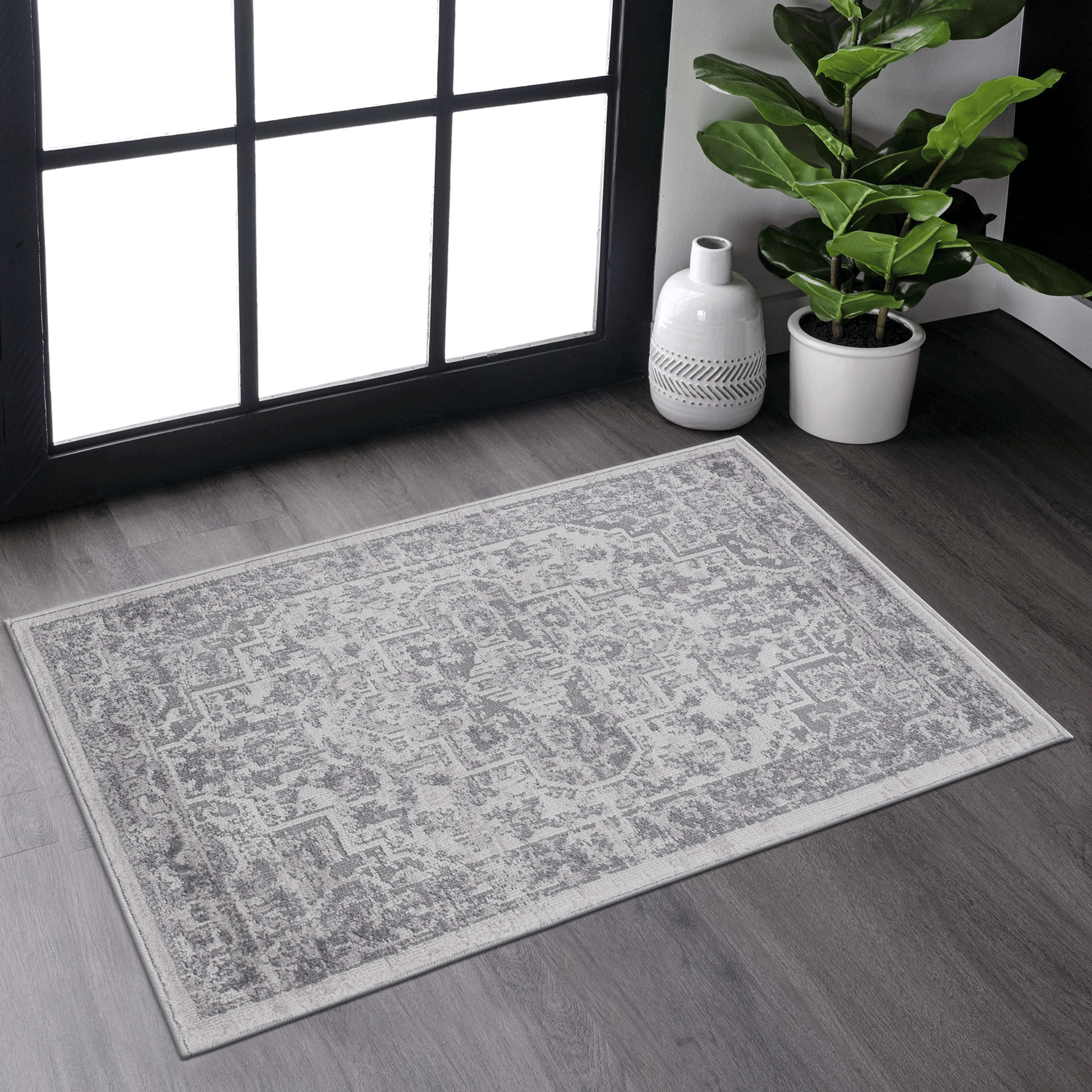 A grey distressed oriental rug with a subtle geometric pattern perfect for entryways