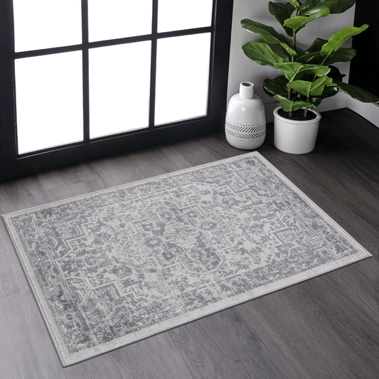 A grey distressed oriental rug with a subtle geometric pattern perfect for entryways