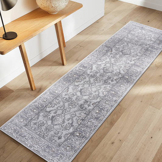 Grey distressed oriental runner rug with detailed medallion pattern on hardwood floor