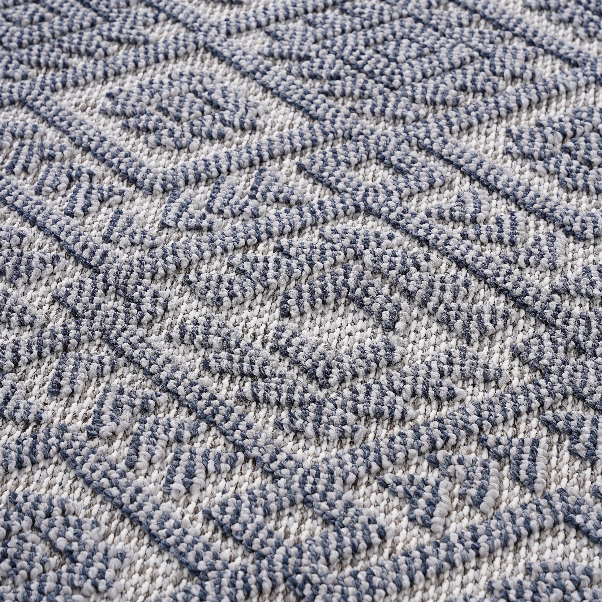 Textured diamond pattern area rug in navy blue and white for living room