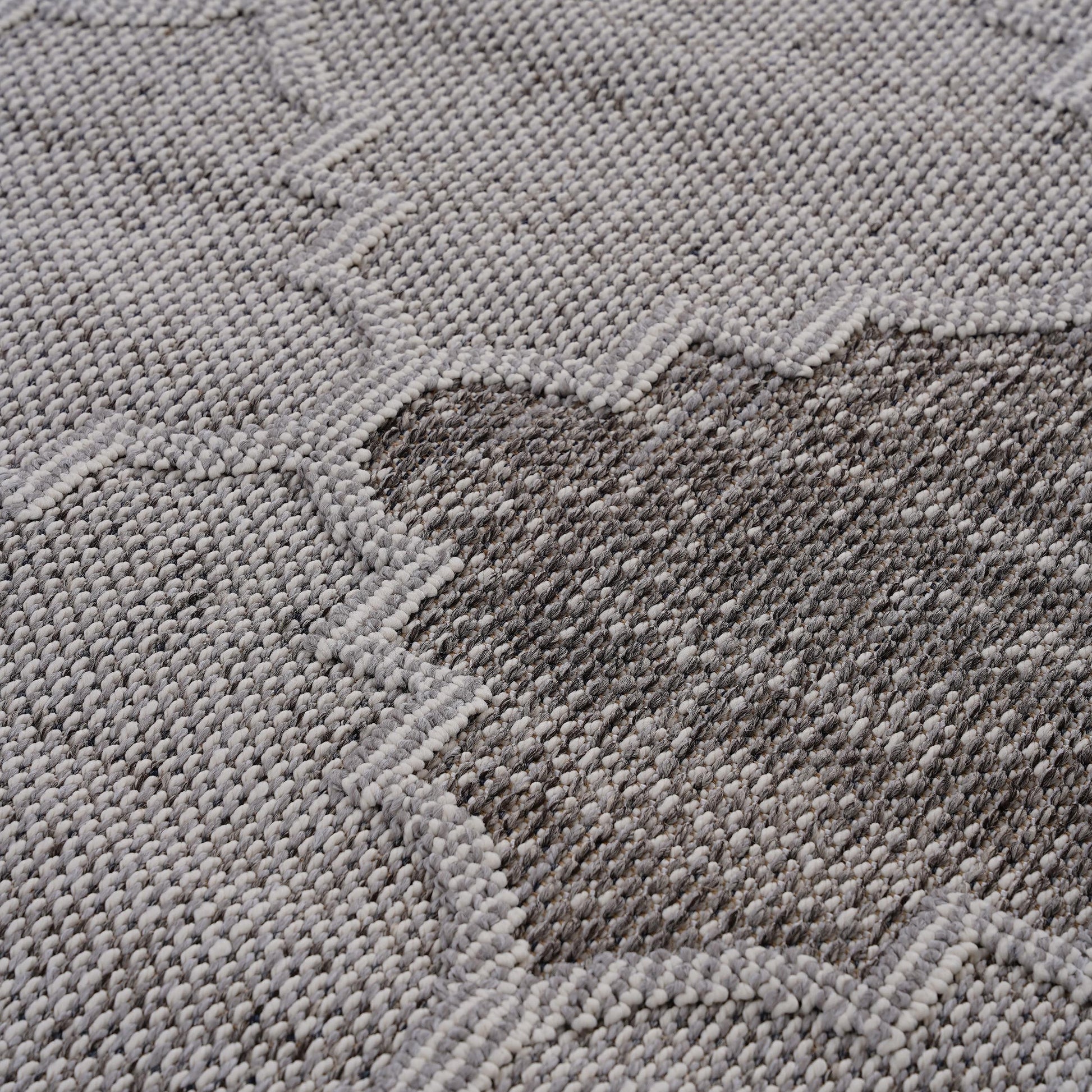 Textured grey and white geometric pattern rug closeup