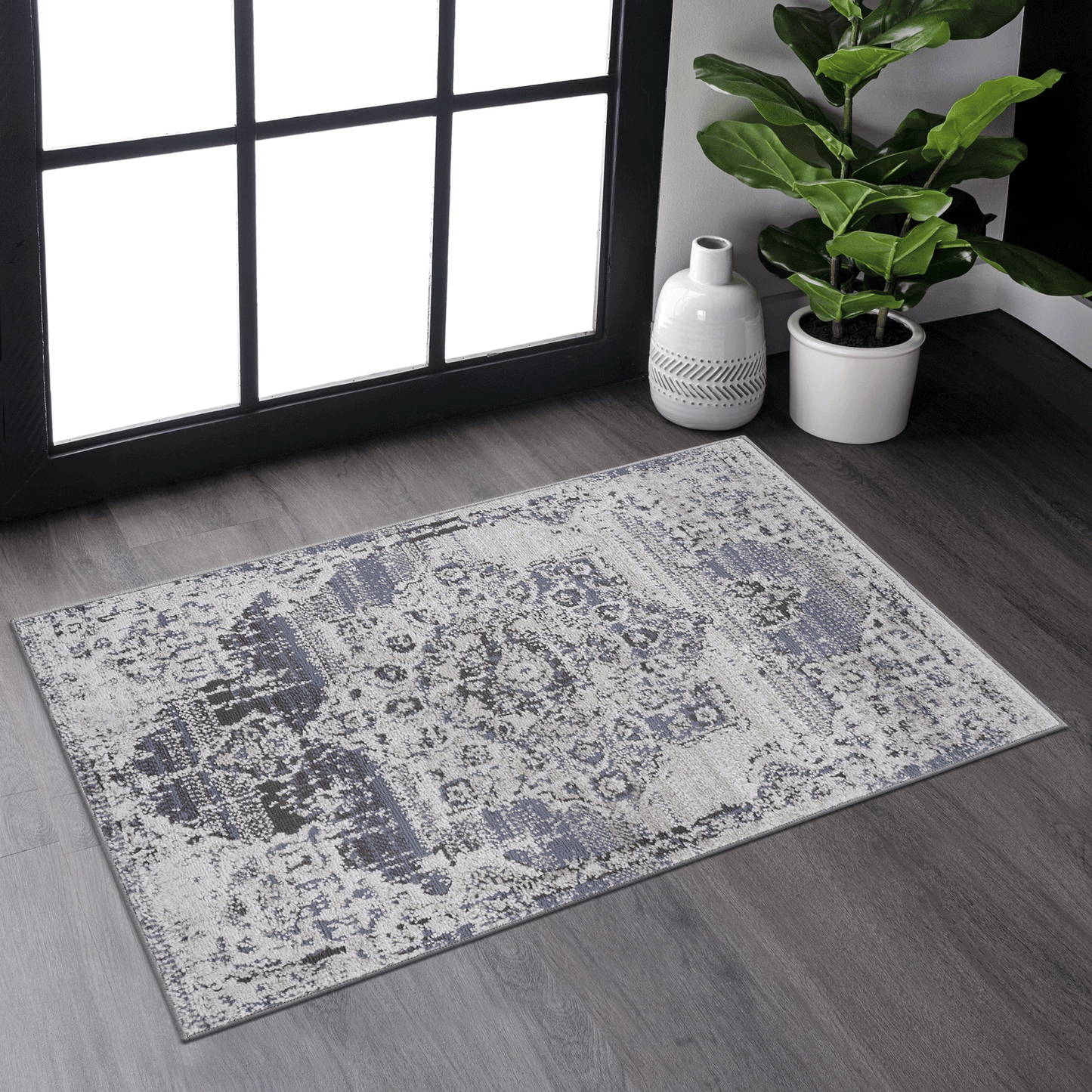 Distressed damask area rug in gray and cream with subtle blue accents for living room decor