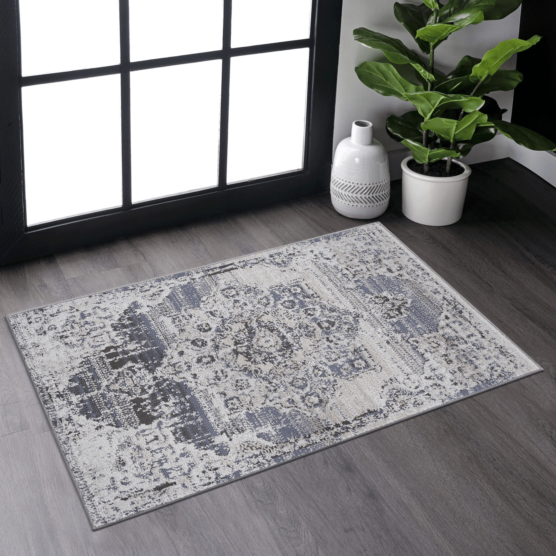 Distressed damask area rug in gray and cream with subtle blue accents for living room decor