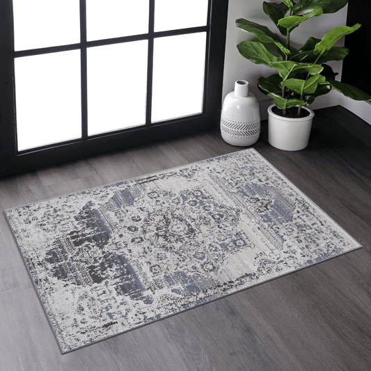 Distressed damask area rug in gray and cream with subtle blue accents for living room decor