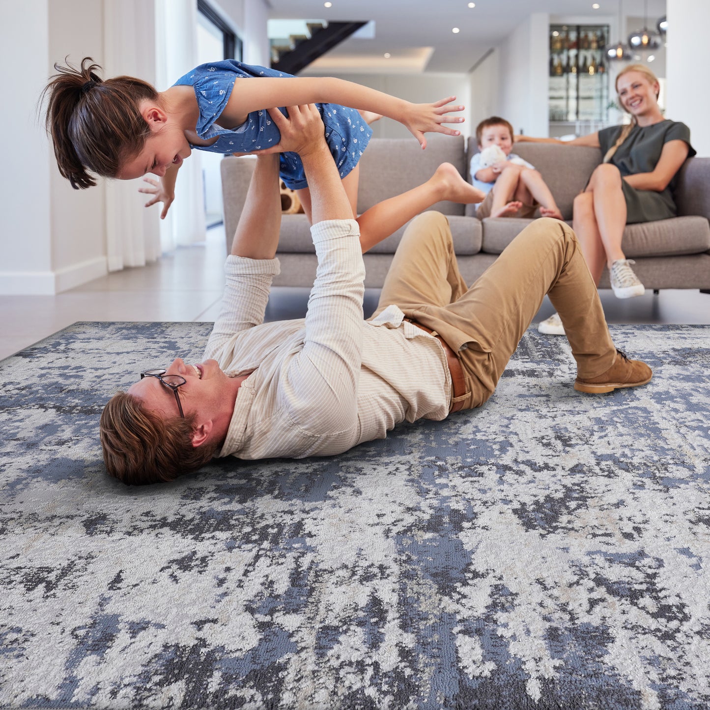 Textured abstract area rug with blue and grey distressed pattern