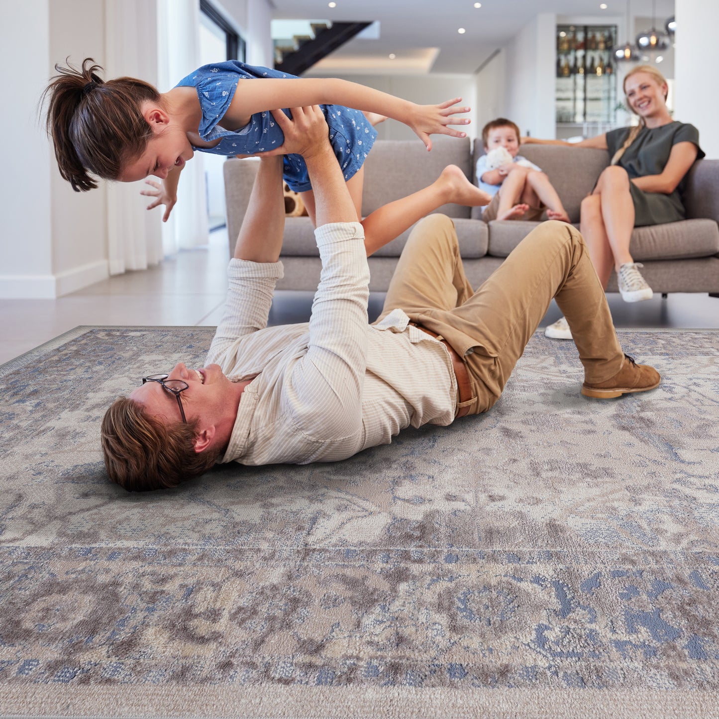 Soft vintageinspired rug with abstract floral patterns in beige and muted blue tones